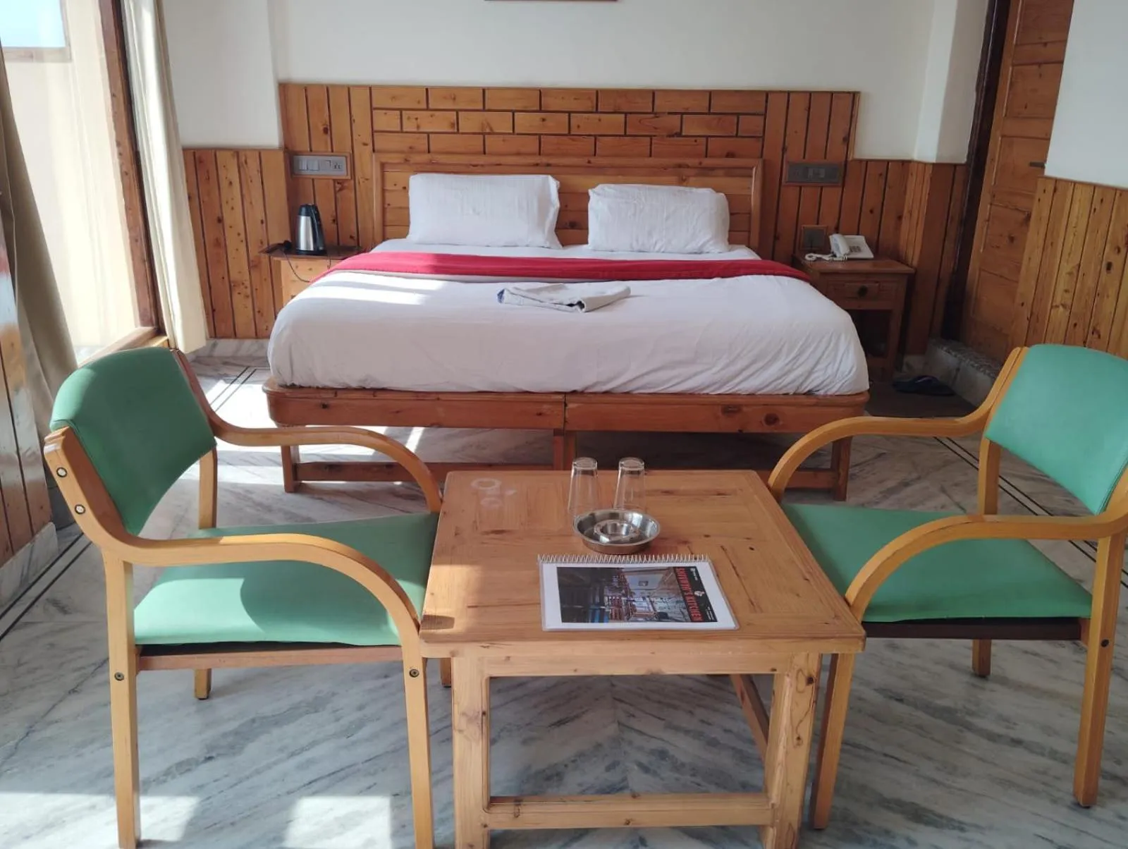 Seating area, Bed in Hotel CM Palace - Pure Vegetarian