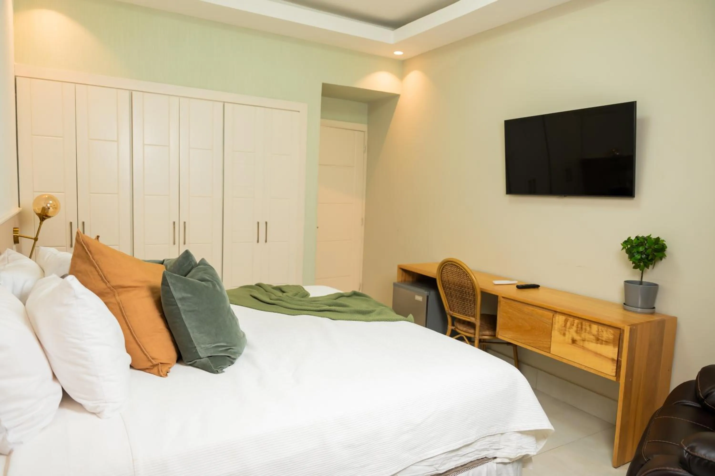 Bed in Hotel Stay Here Suites