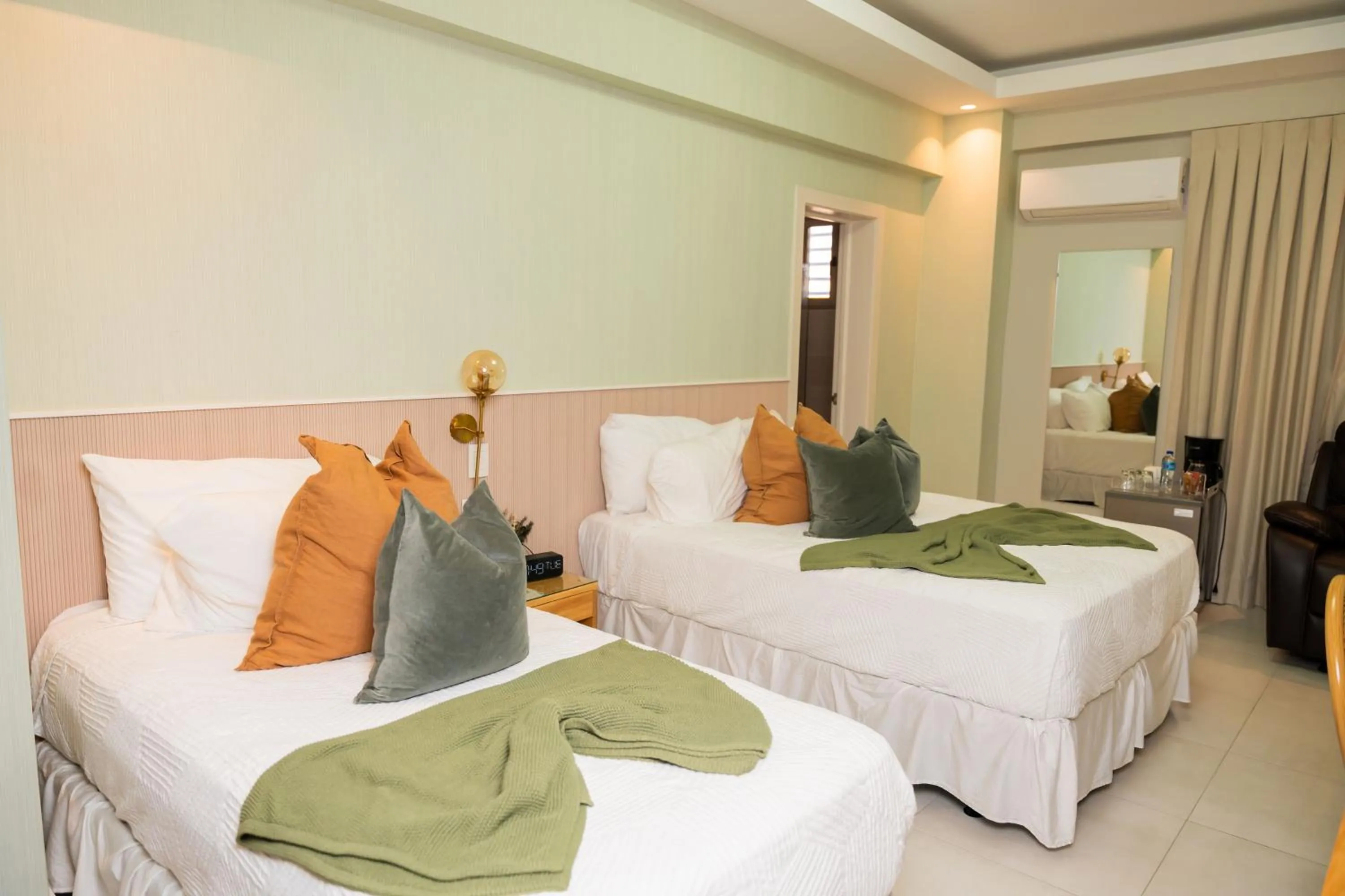 Bed in Hotel Stay Here Suites