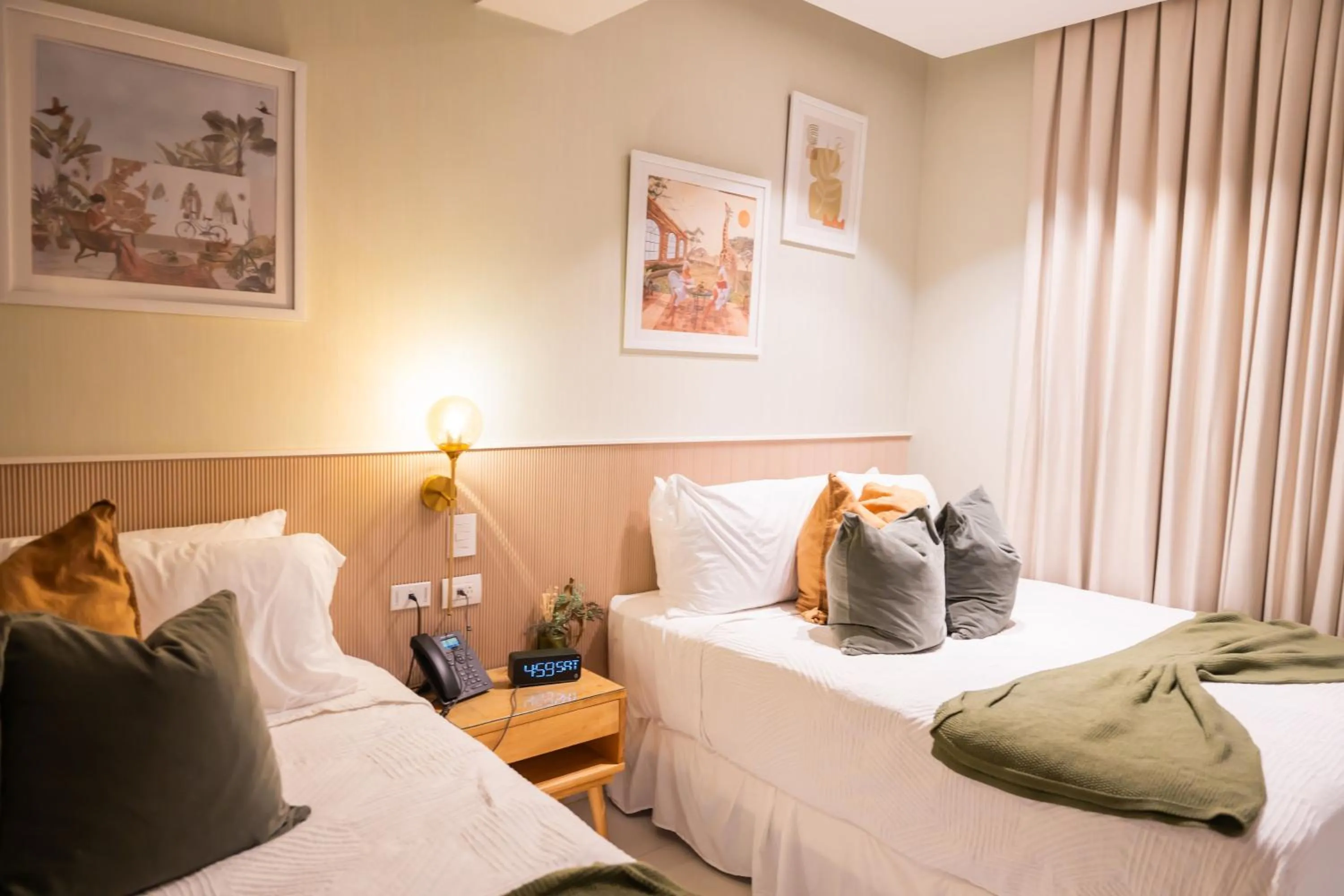 Living room, Bed in Hotel Stay Here Suites