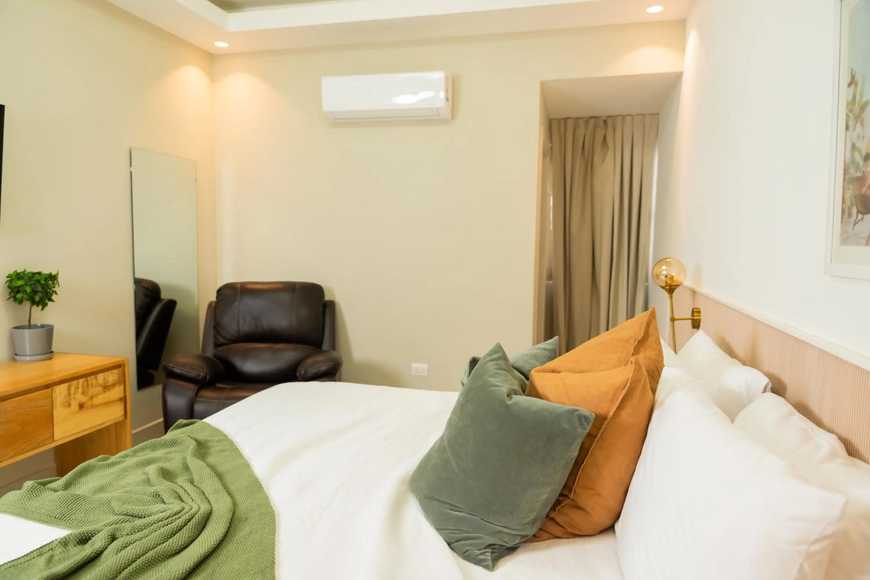 Bed in Hotel Stay Here Suites