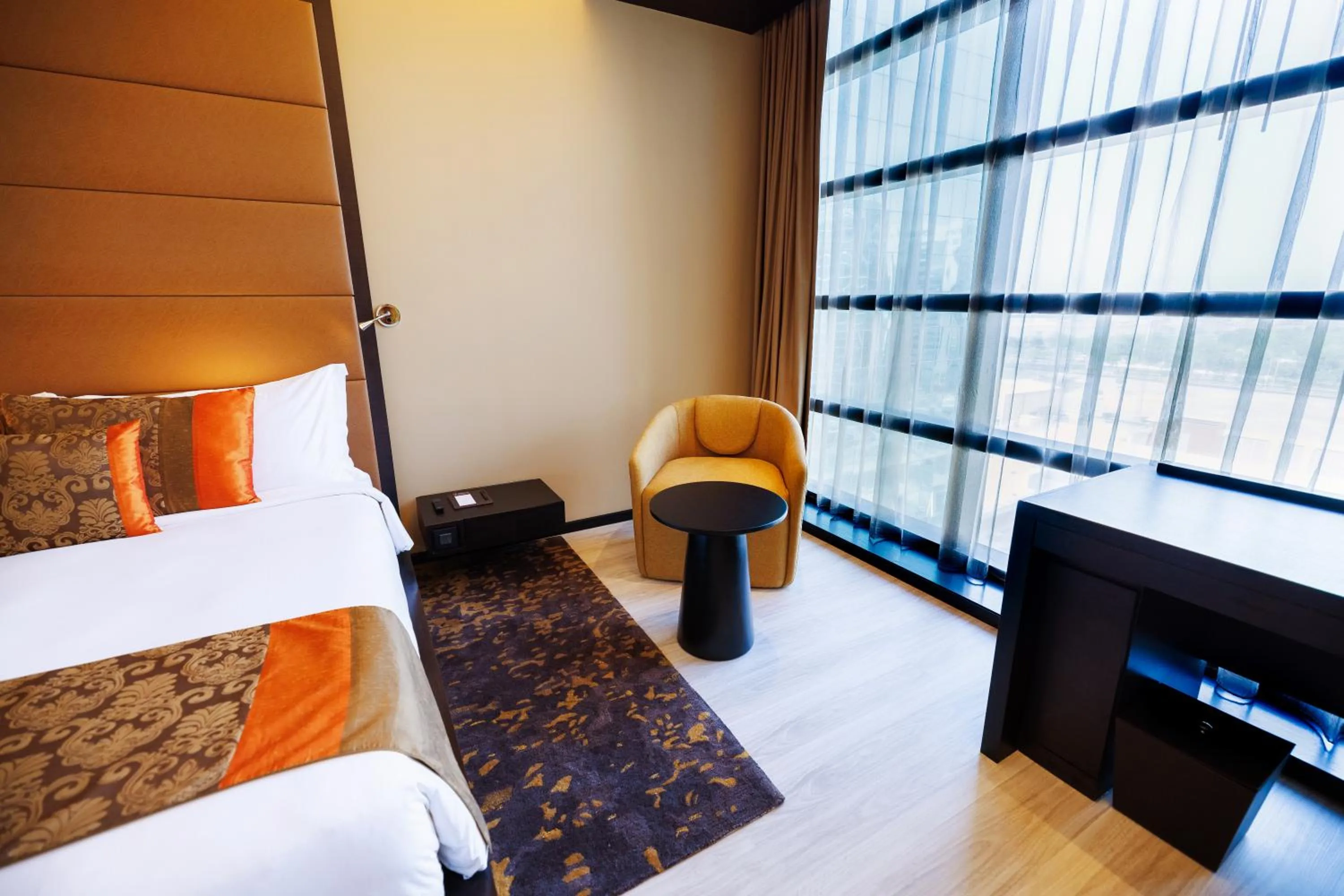 Seating area, Bed in Southern Sun Abu Dhabi