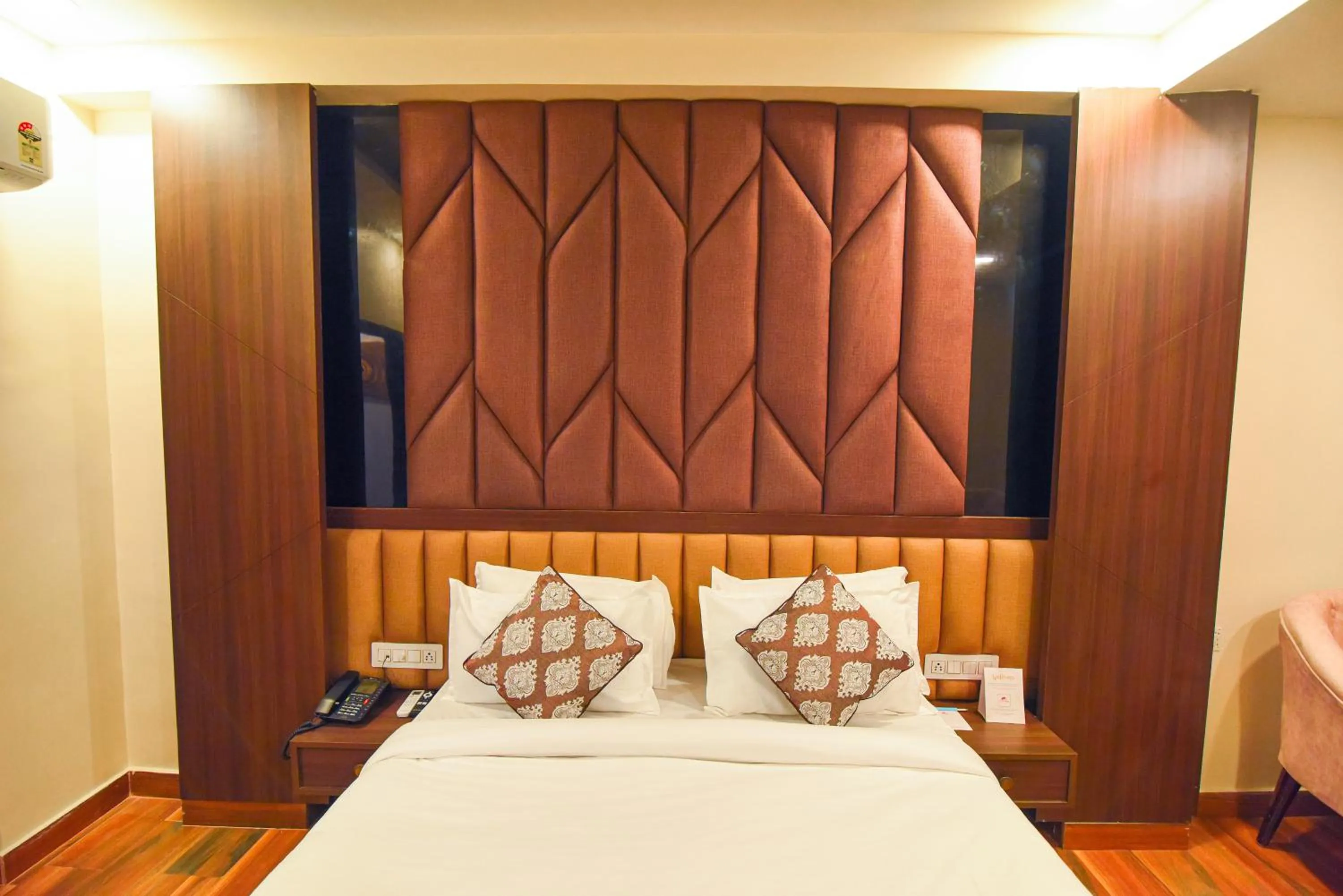 Bed in Hotel Swagat Suites