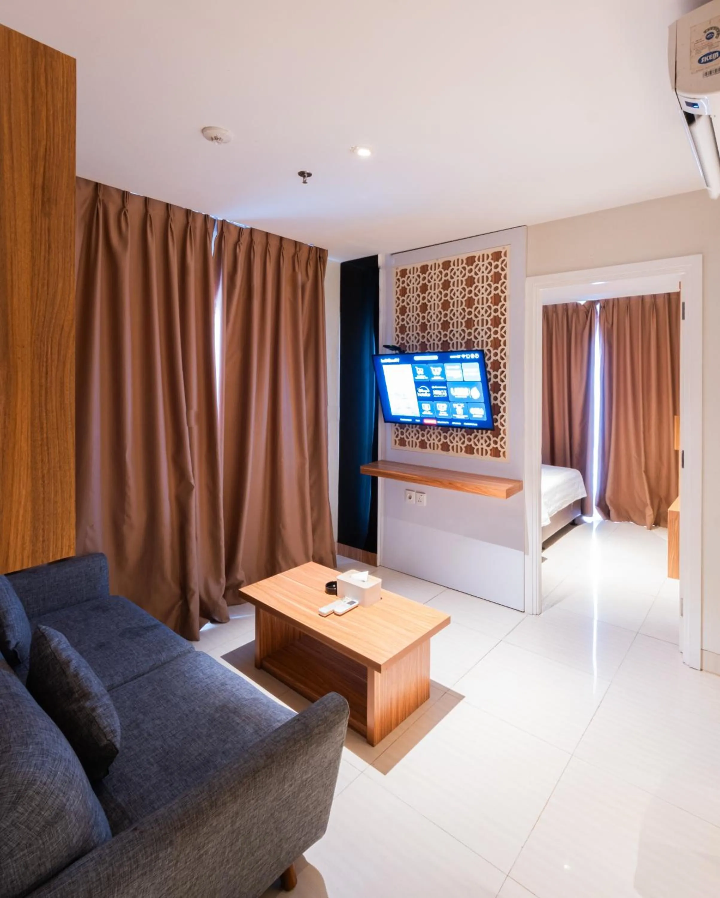 Communal lounge/ TV room, Bed in Astara Hotel Balikpapan