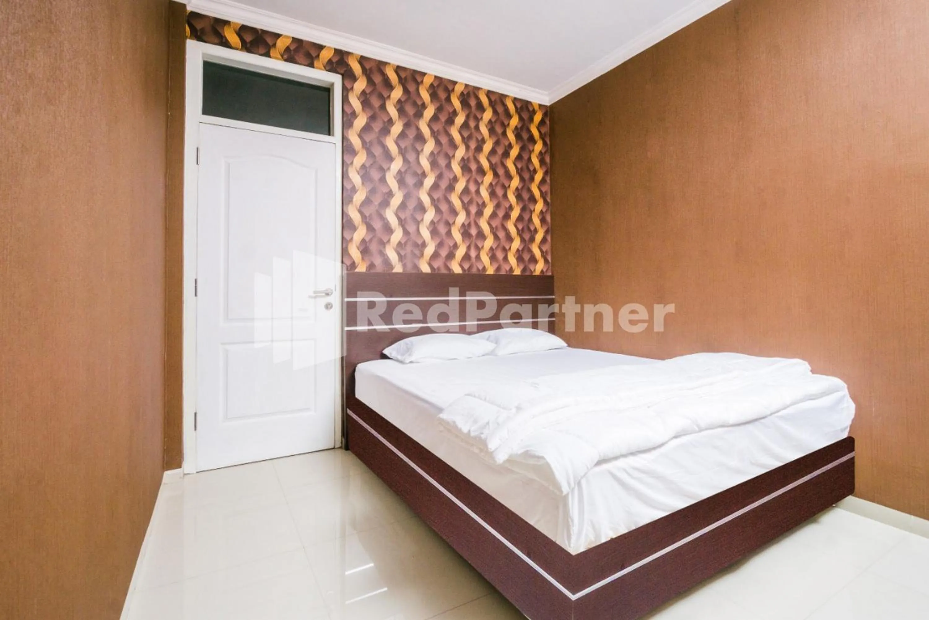 Bed in Omah Kalimosodo Mitra RedDoorz near Stasiun Malang Kota Baru