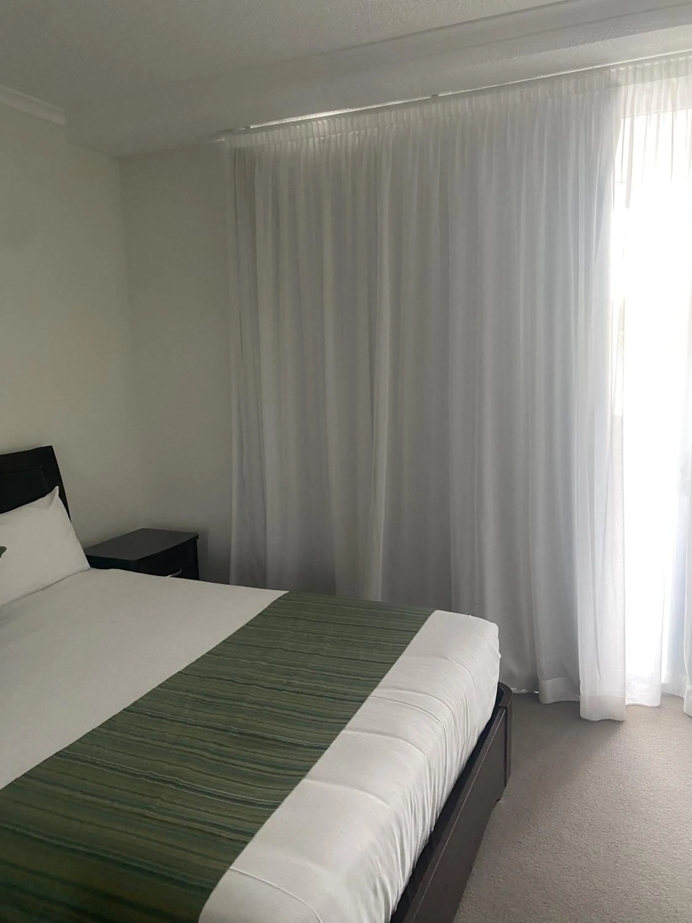 Bedroom, Bed in Curtis Central Apartments Official