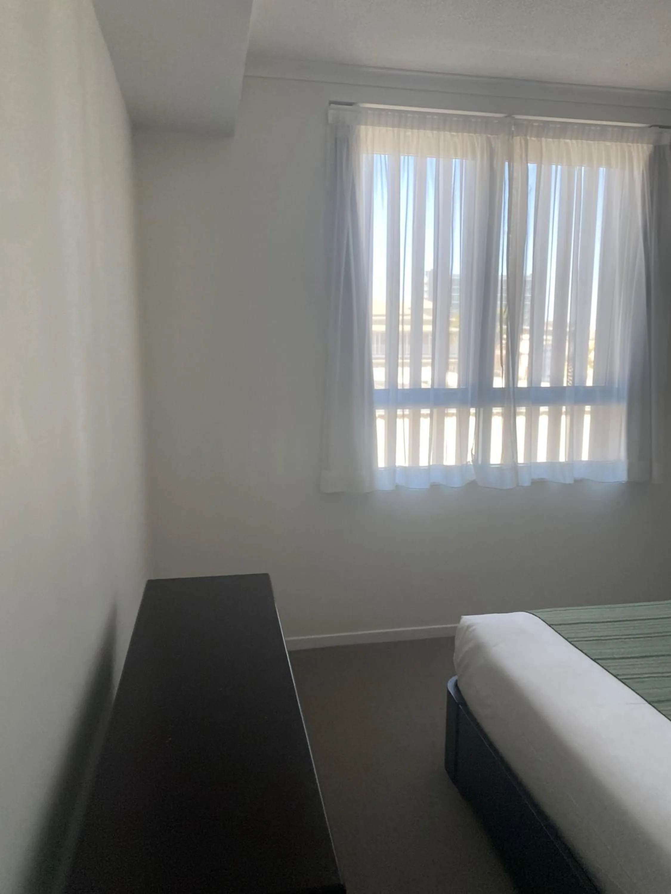 Bed in Curtis Central Apartments Official