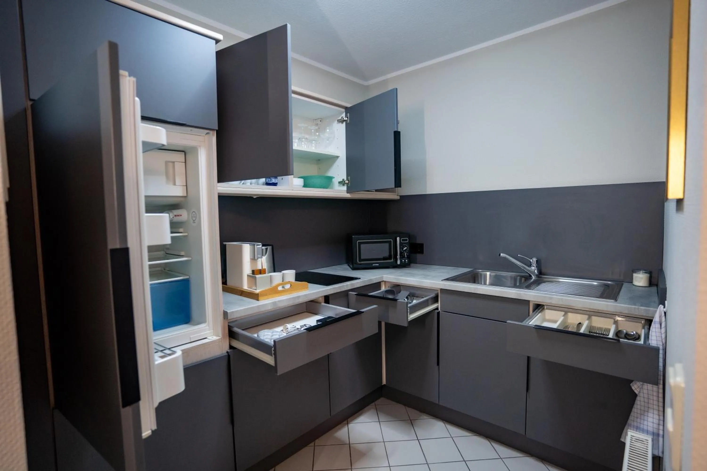 Kitchen or kitchenette in Hotel CityHome am Kurpark