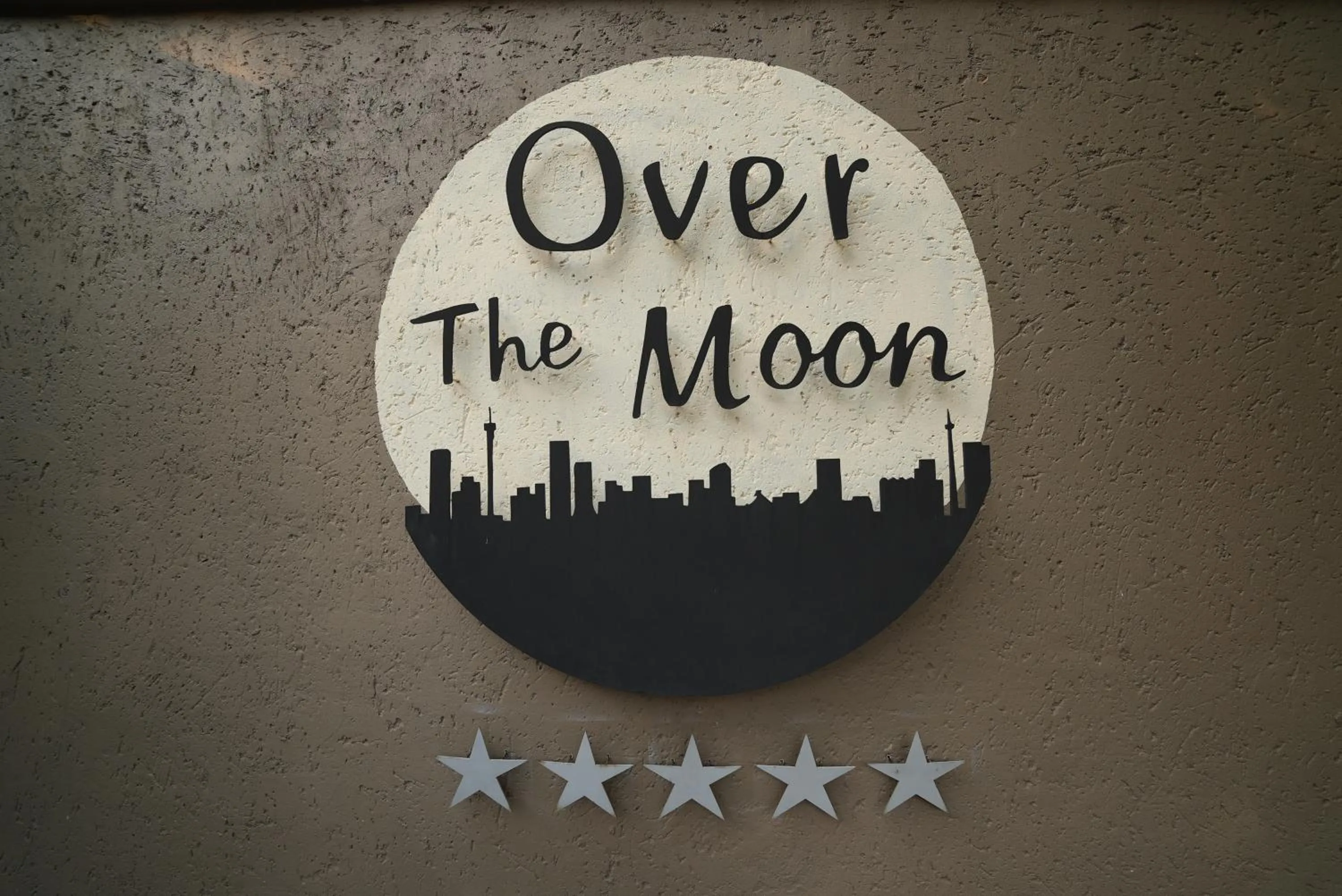 Property logo or sign in Over The Moon Guesthouse