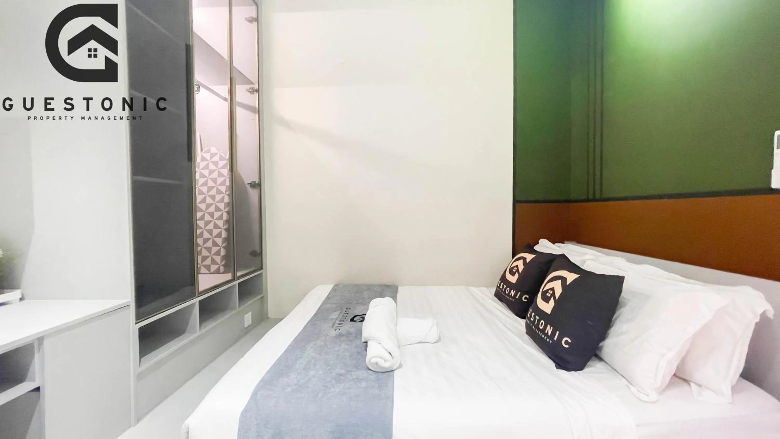 Bed in NeuSuite Cozy Studio by GUESTONIC