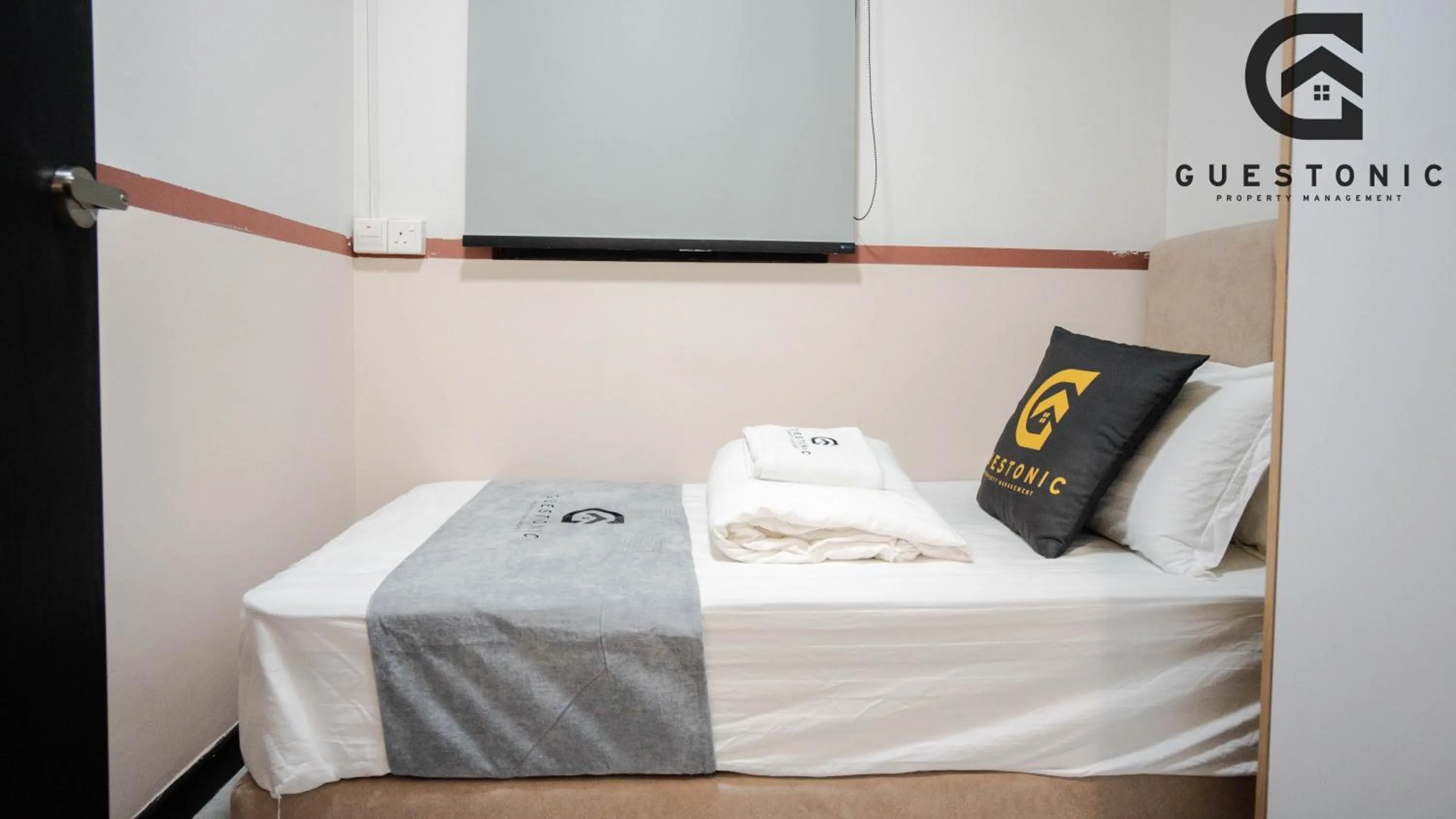 Bed in NeuSuite Cozy Studio by GUESTONIC