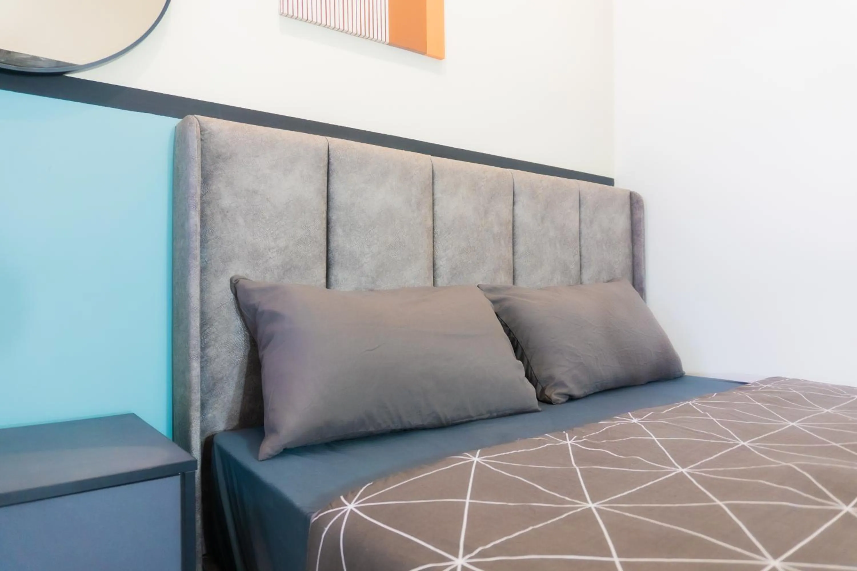 Bed in NeuSuite Cozy Studio by GUESTONIC