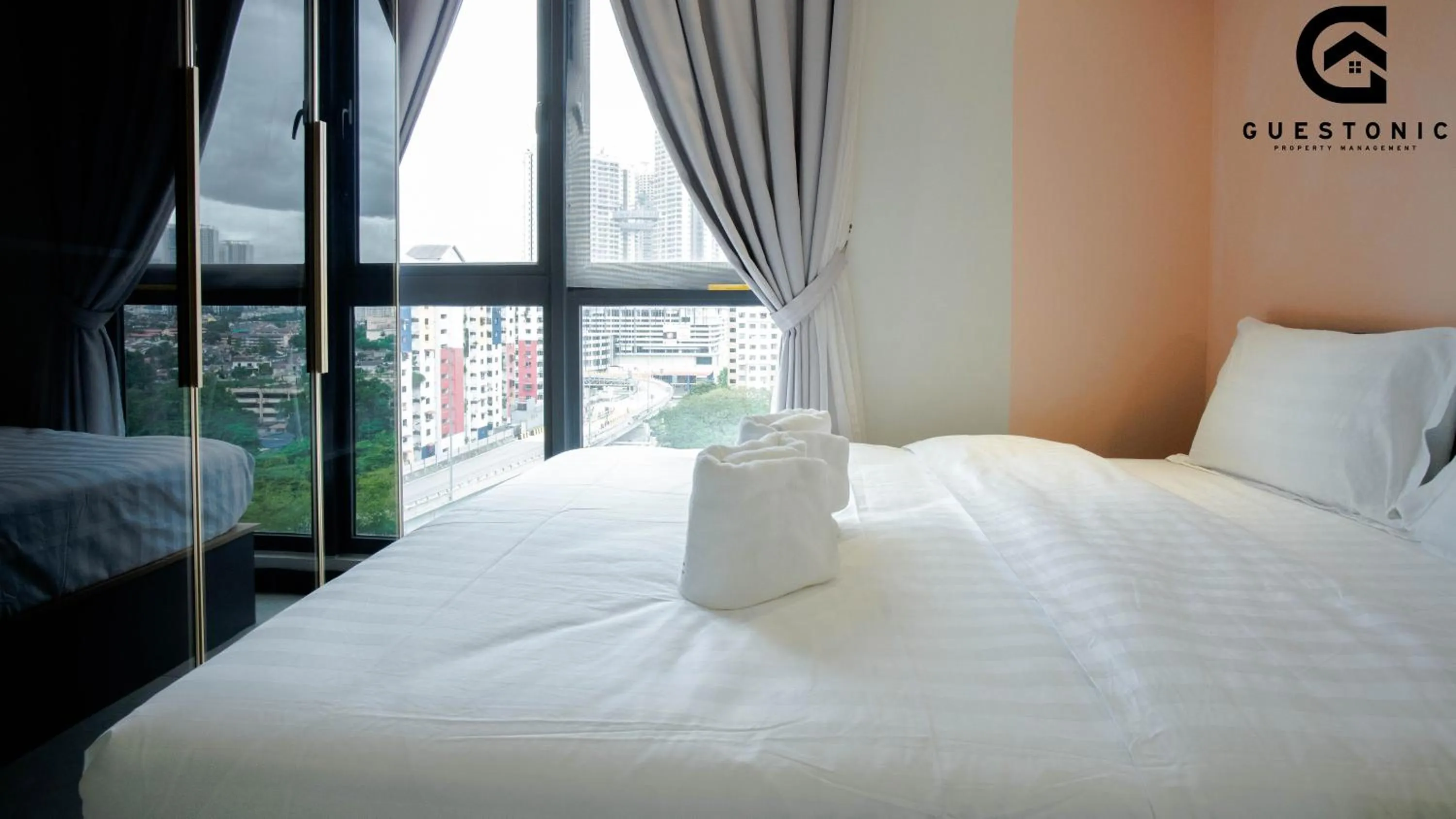 Bed in NeuSuite Cozy Studio by GUESTONIC