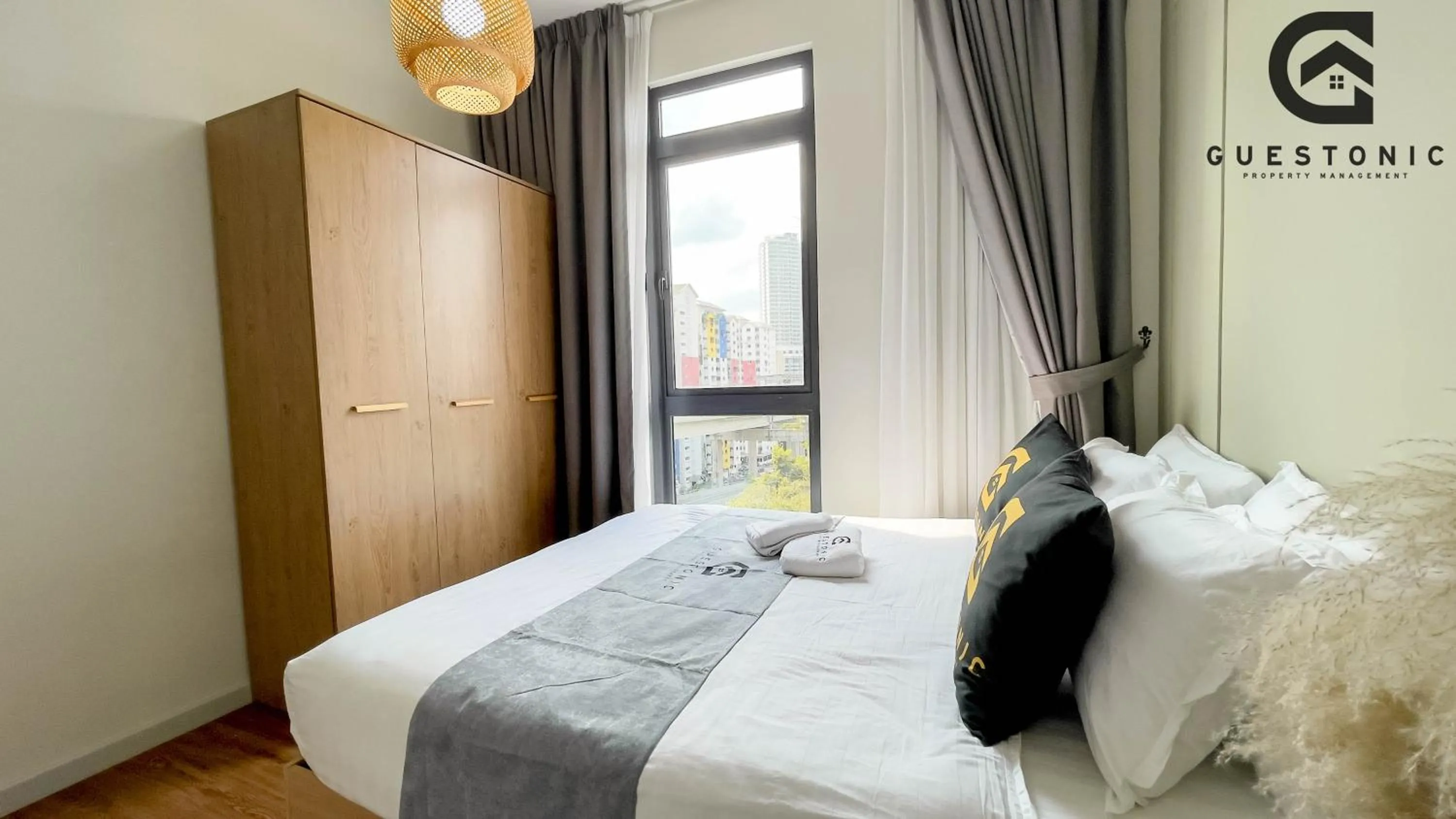 Bed in NeuSuite Cozy Studio by GUESTONIC