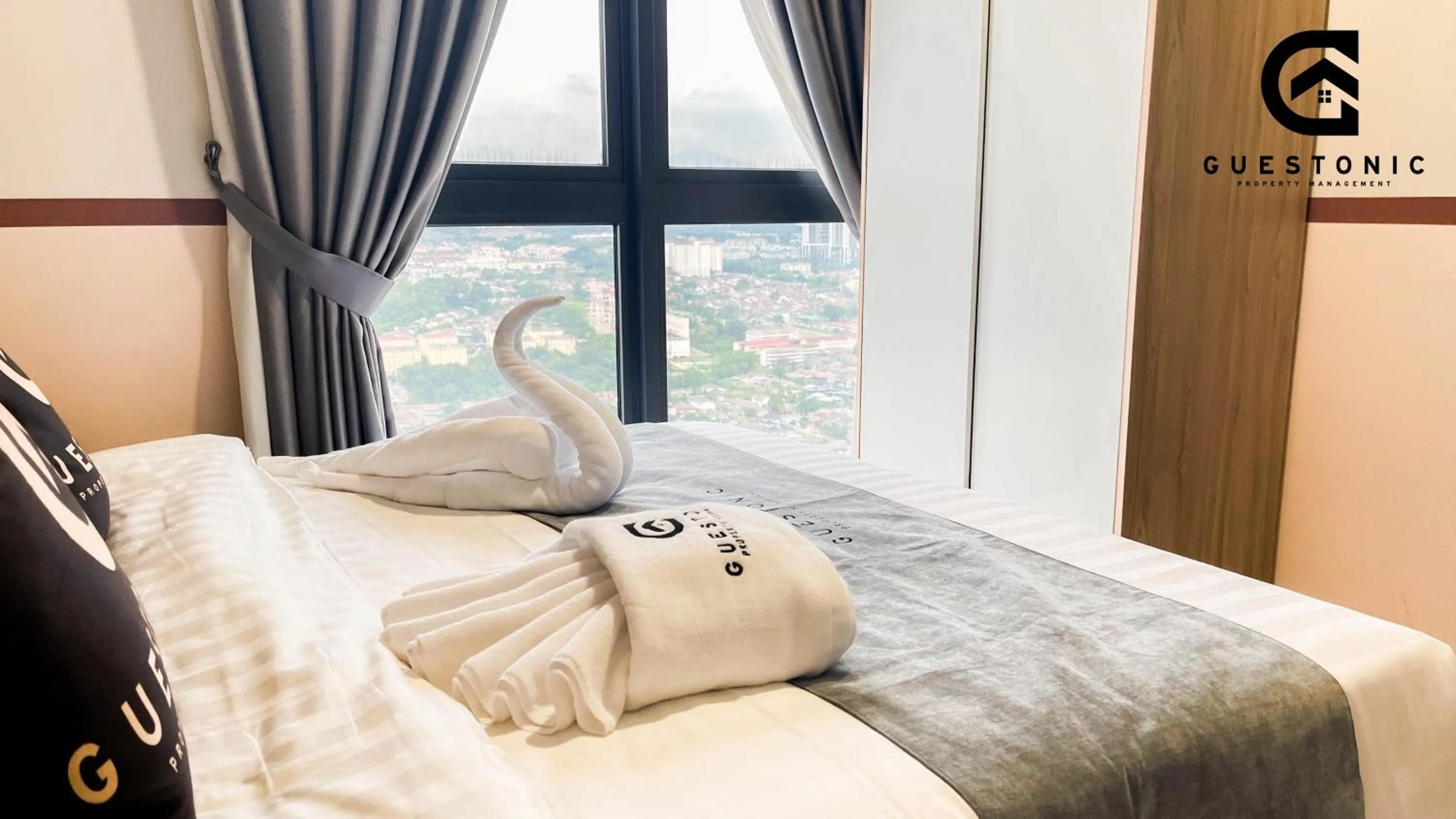 Bed in NeuSuite Cozy Studio by GUESTONIC