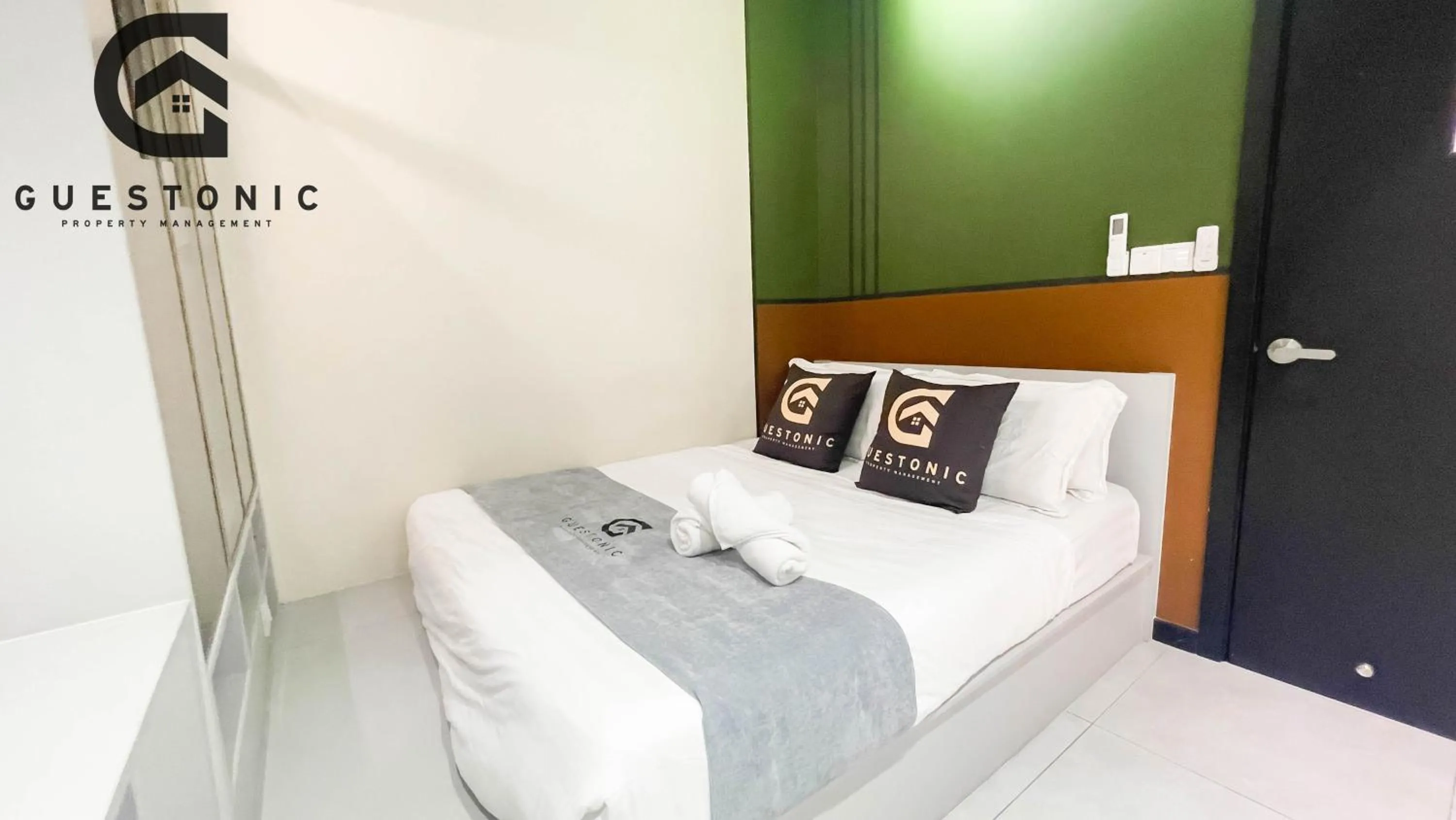 Bed in NeuSuite Cozy Studio by GUESTONIC