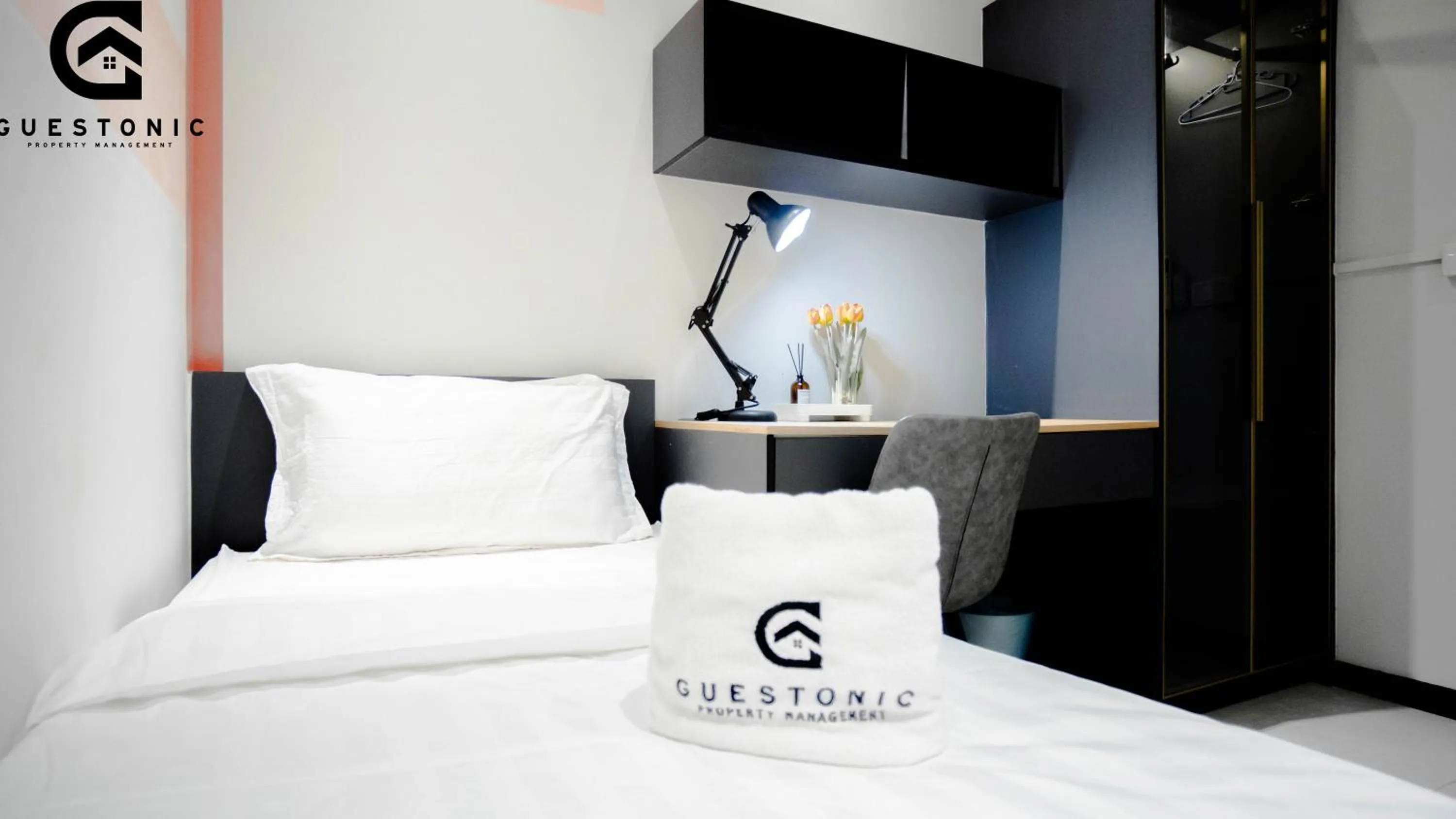 Bed in NeuSuite Cozy Studio by GUESTONIC