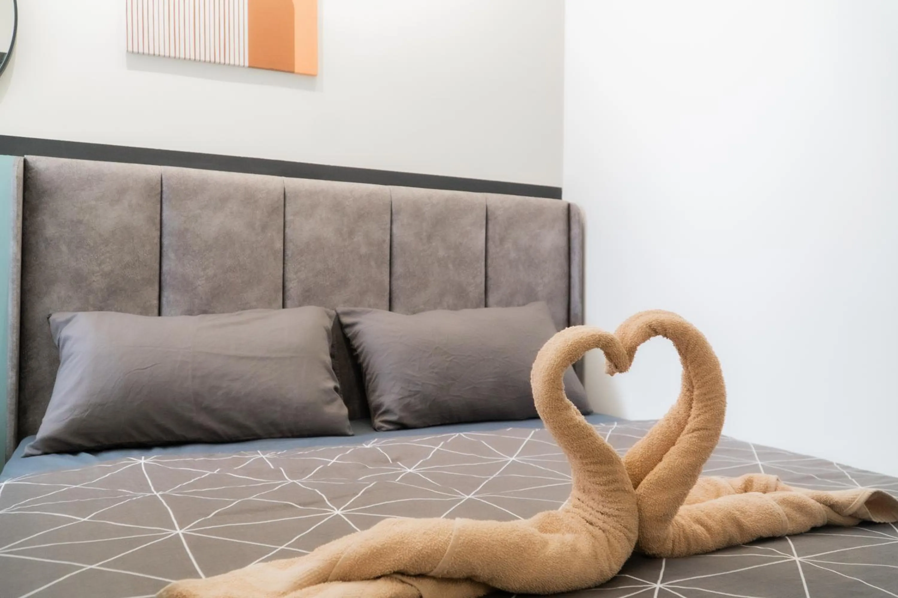 Bed in NeuSuite Cozy Studio by GUESTONIC