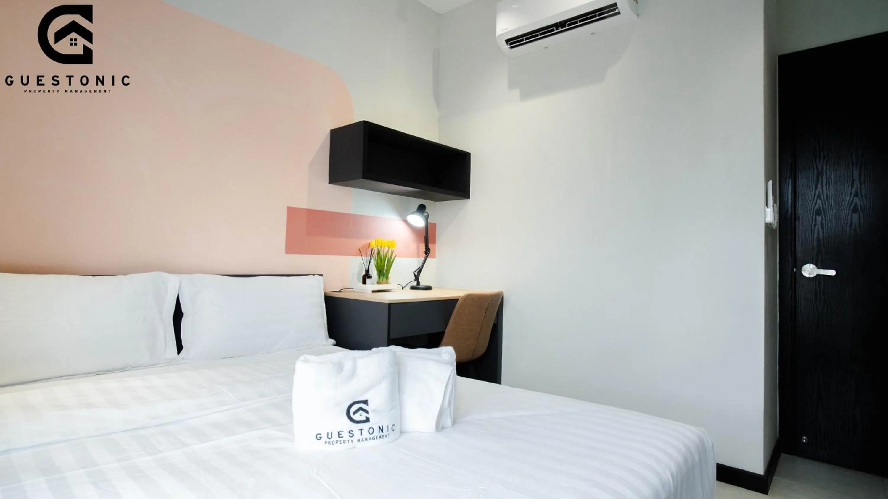 Bed in NeuSuite Cozy Studio by GUESTONIC