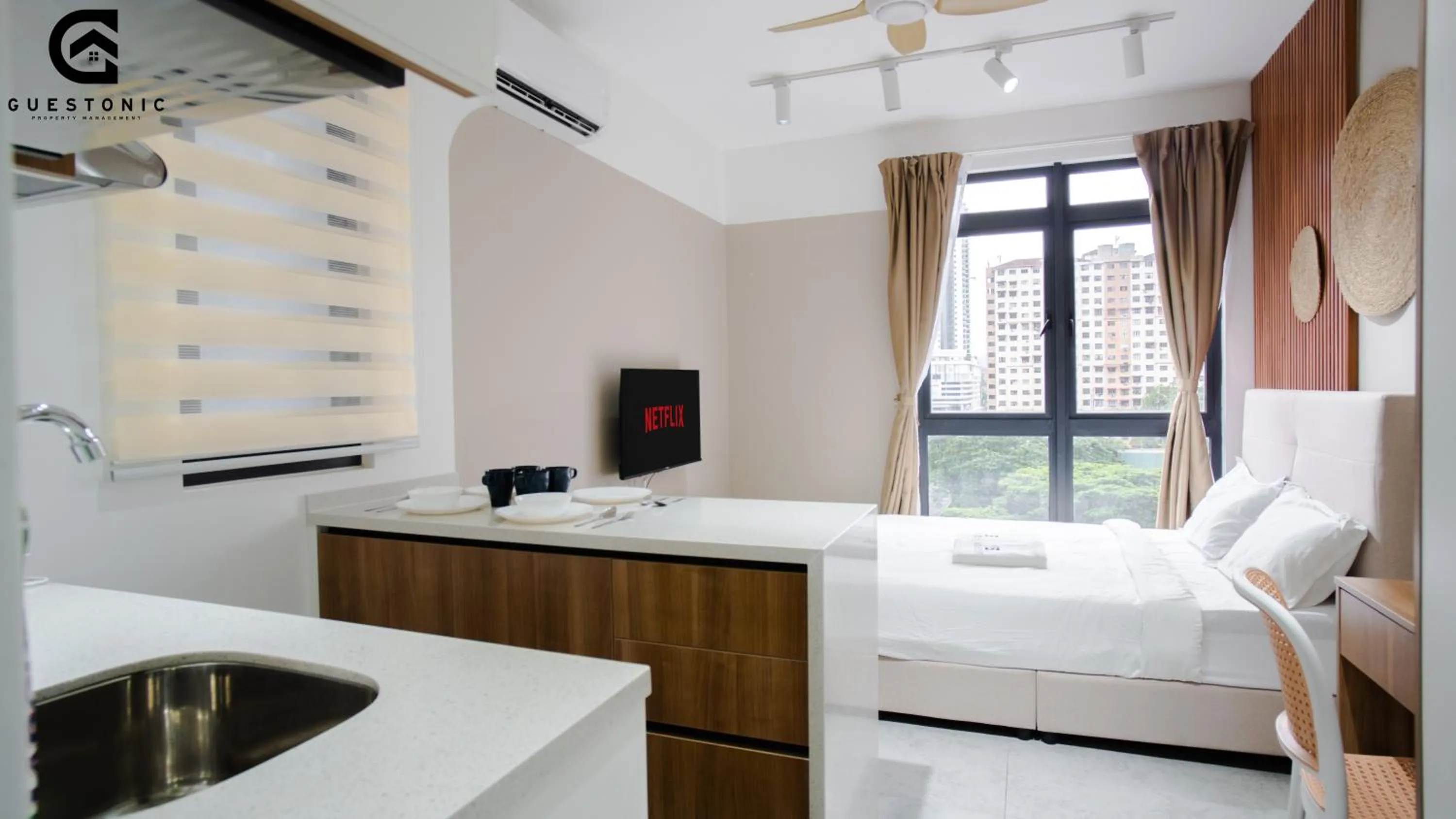 Bed in NeuSuite Cozy Studio by GUESTONIC