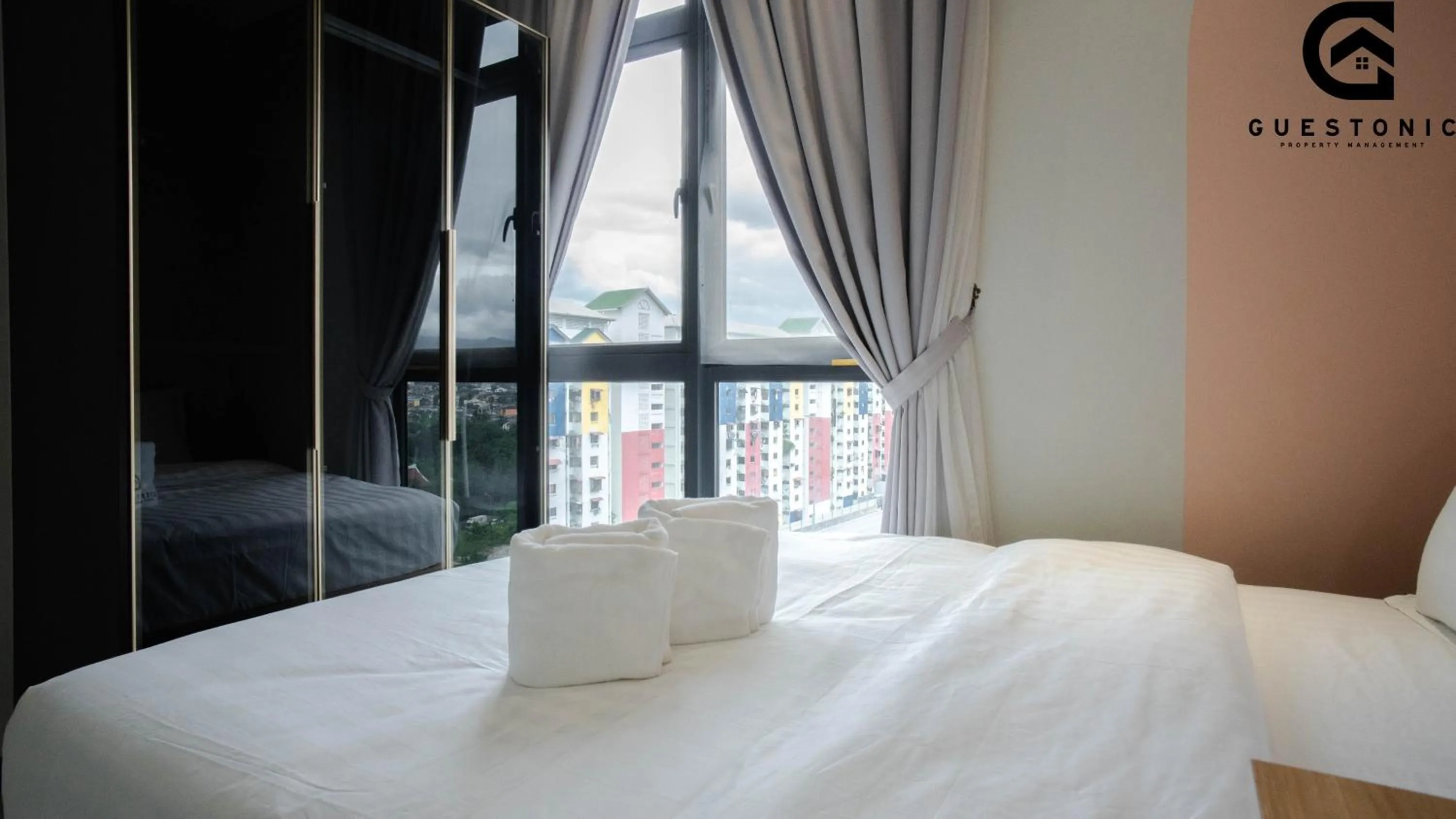 Bed in NeuSuite Cozy Studio by GUESTONIC