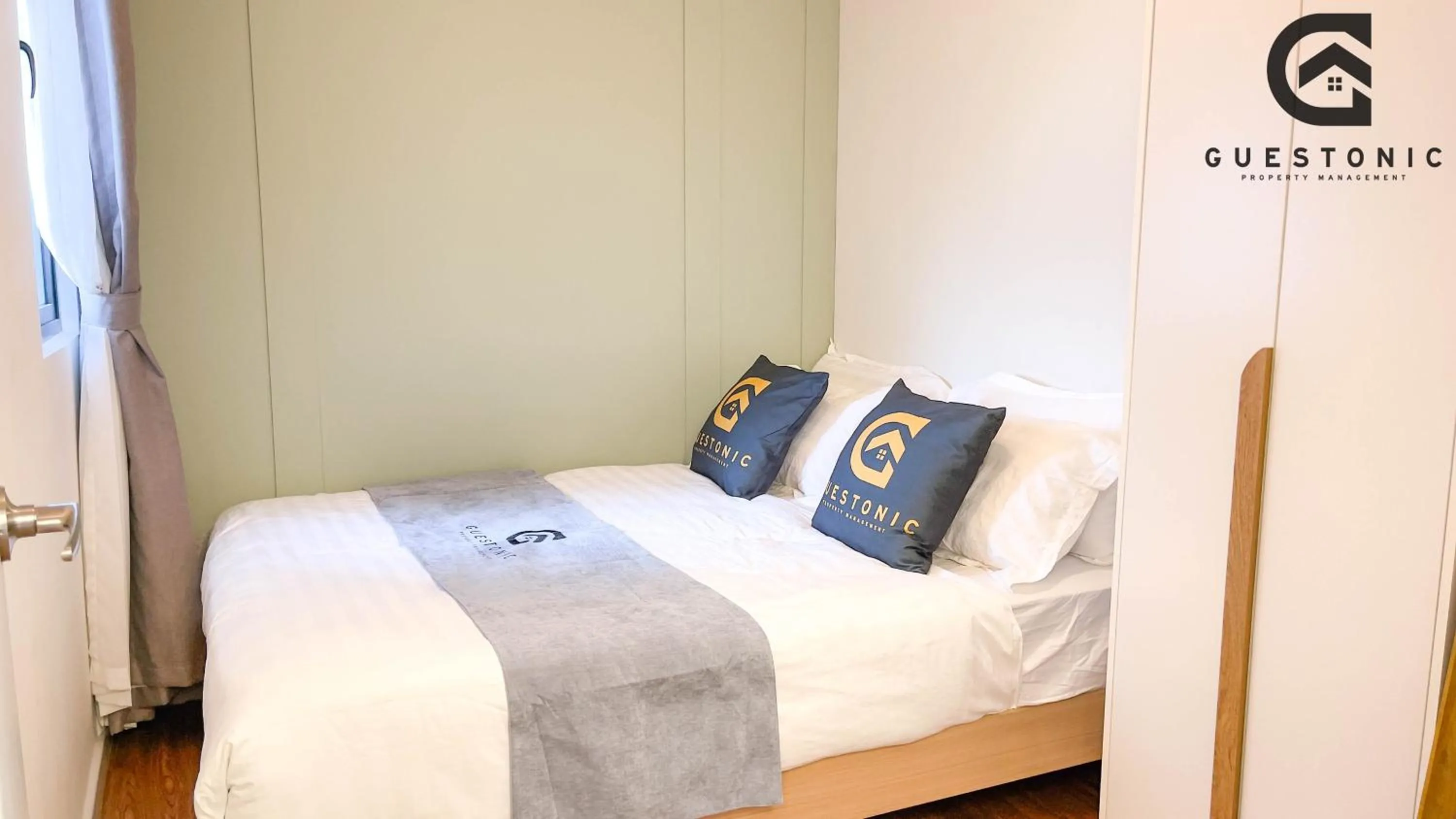 Bed in NeuSuite Cozy Studio by GUESTONIC