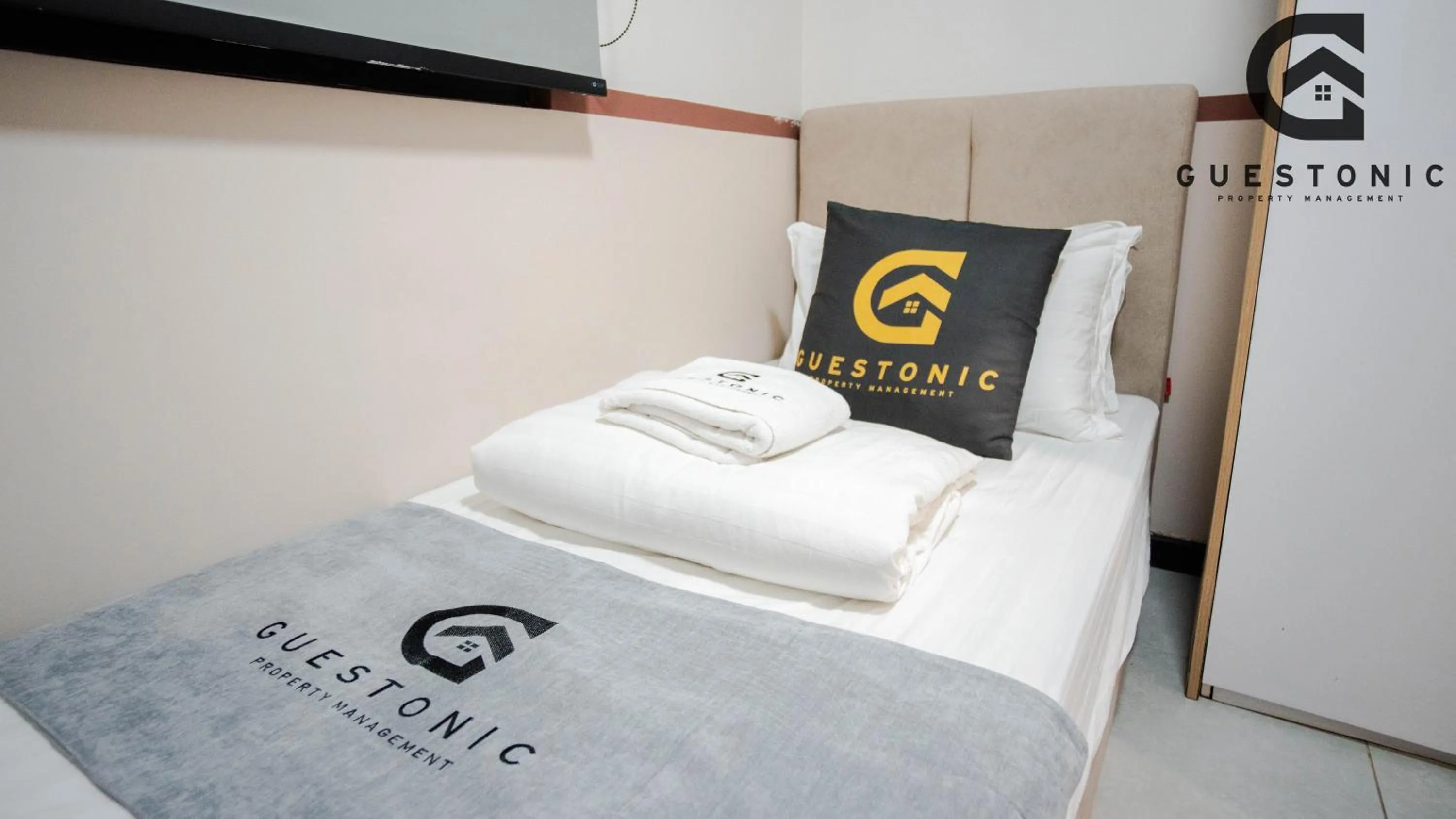 Bed in NeuSuite Cozy Studio by GUESTONIC