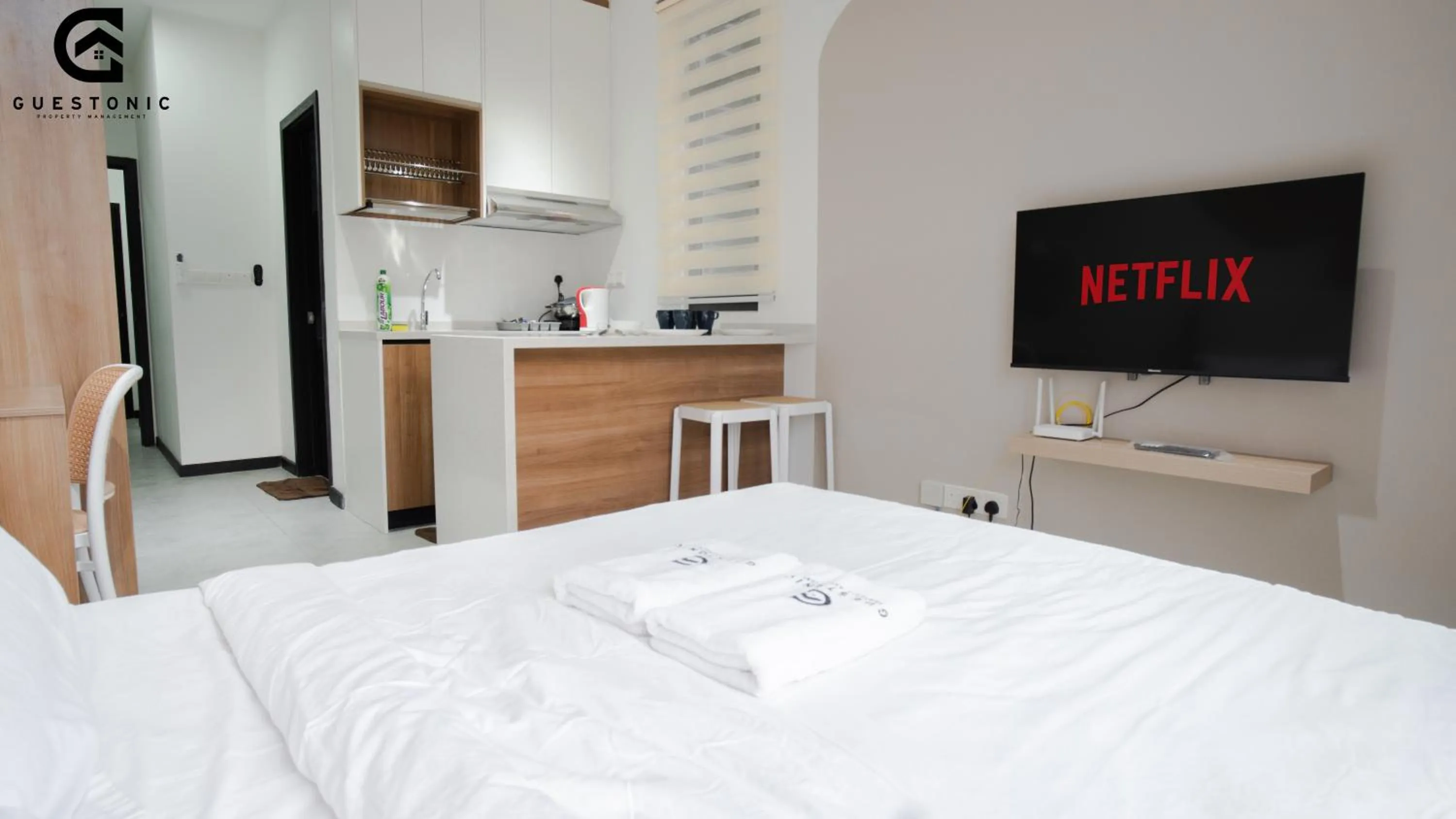 Bed in NeuSuite Cozy Studio by GUESTONIC