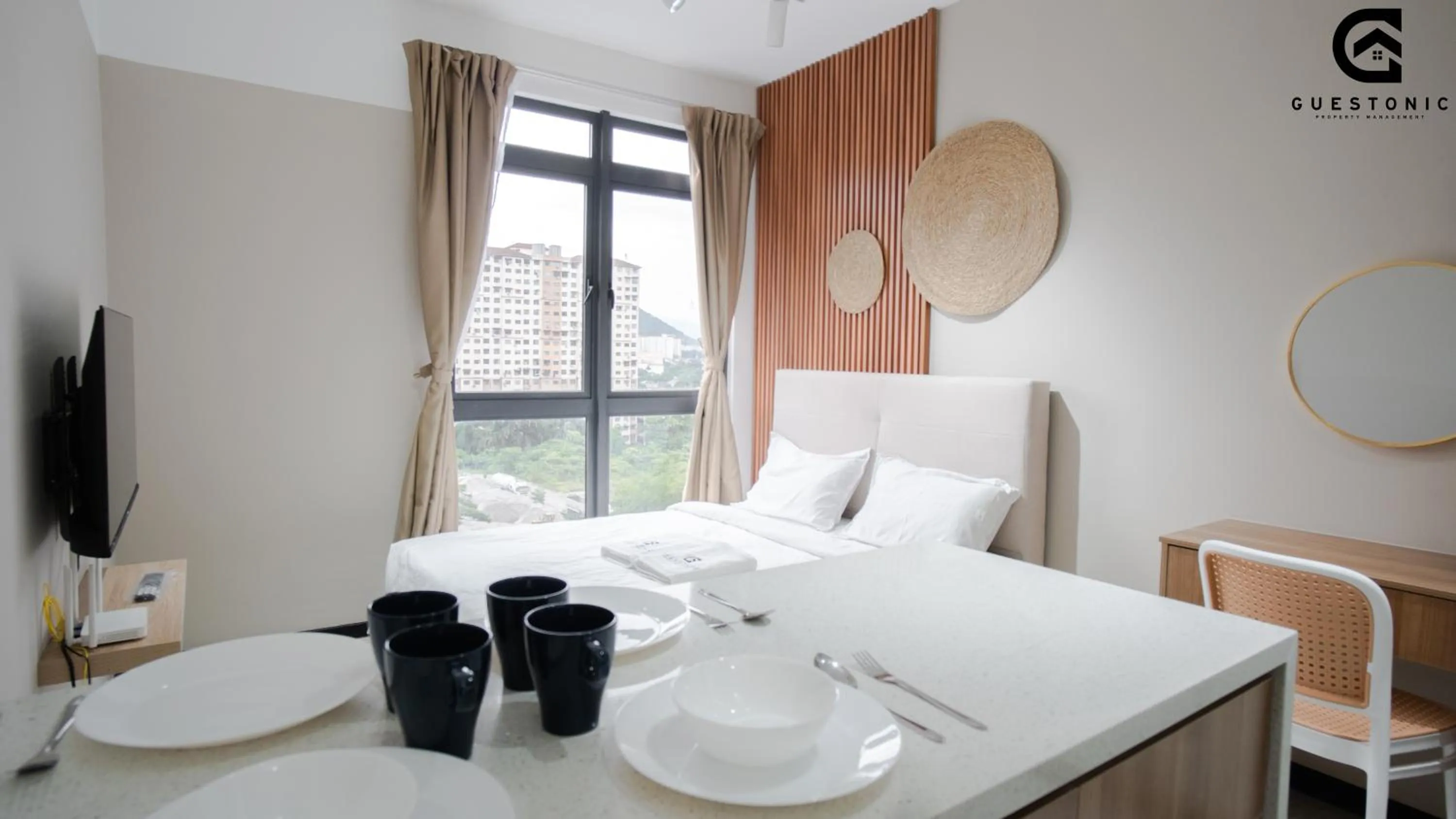 Bed in NeuSuite Cozy Studio by GUESTONIC