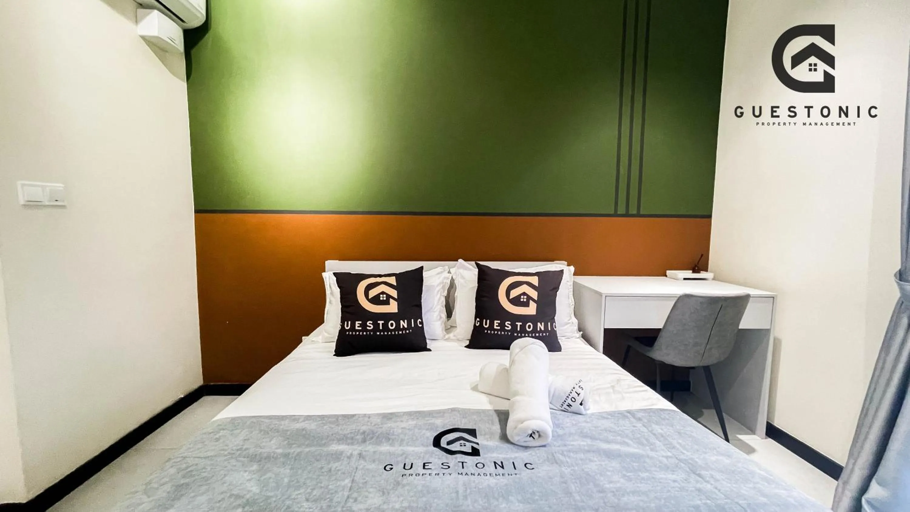 Bed in NeuSuite Cozy Studio by GUESTONIC