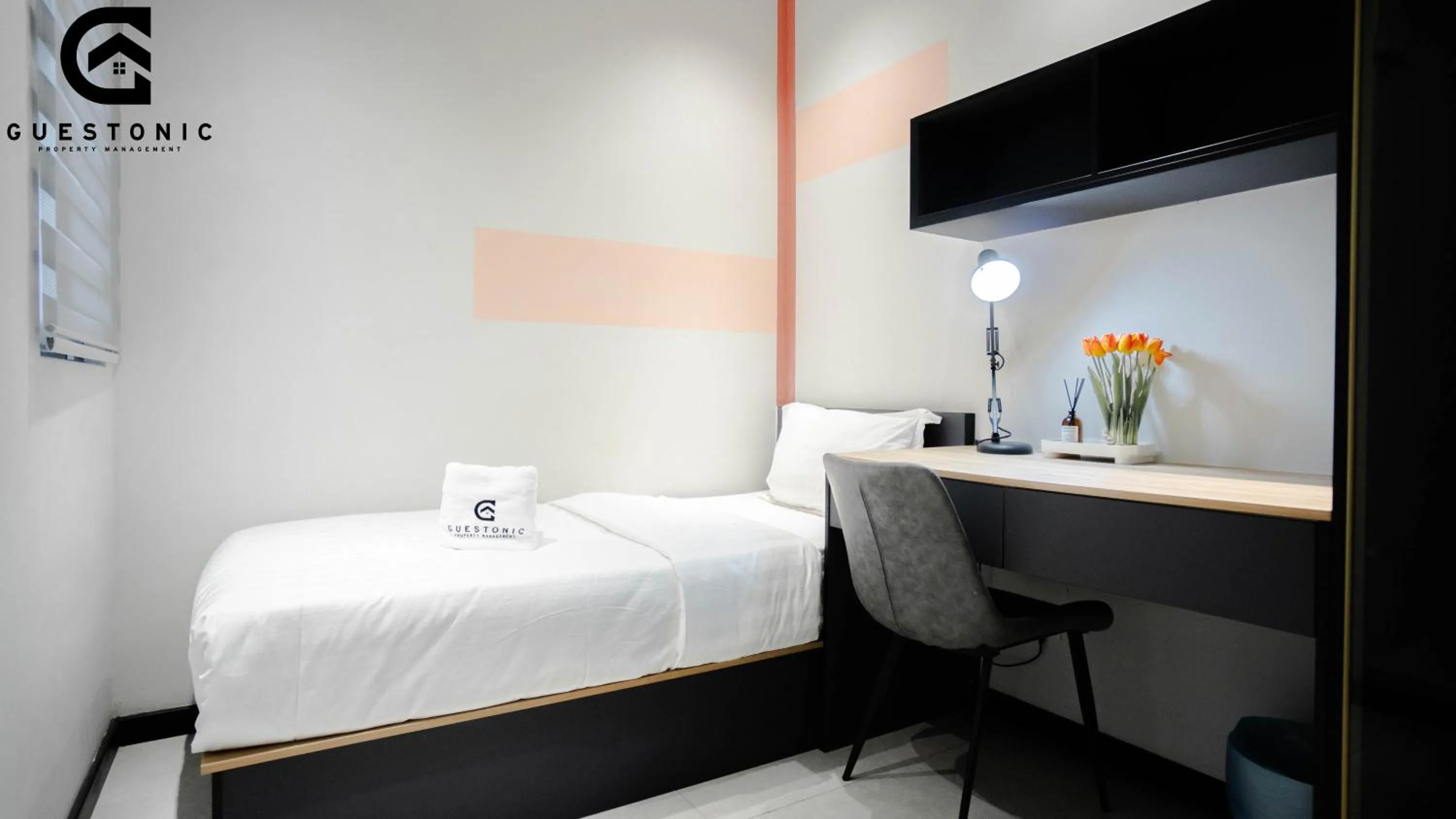 Bed in NeuSuite Cozy Studio by GUESTONIC