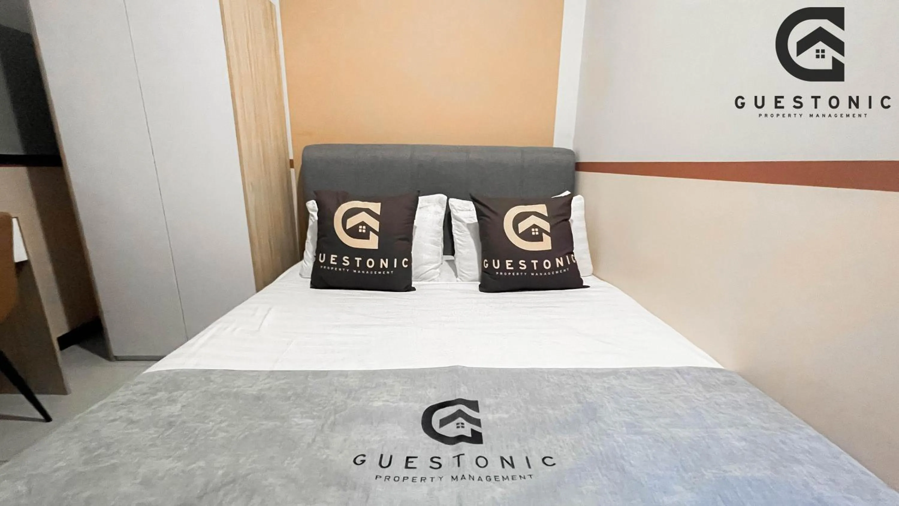 Bed in NeuSuite Cozy Studio by GUESTONIC