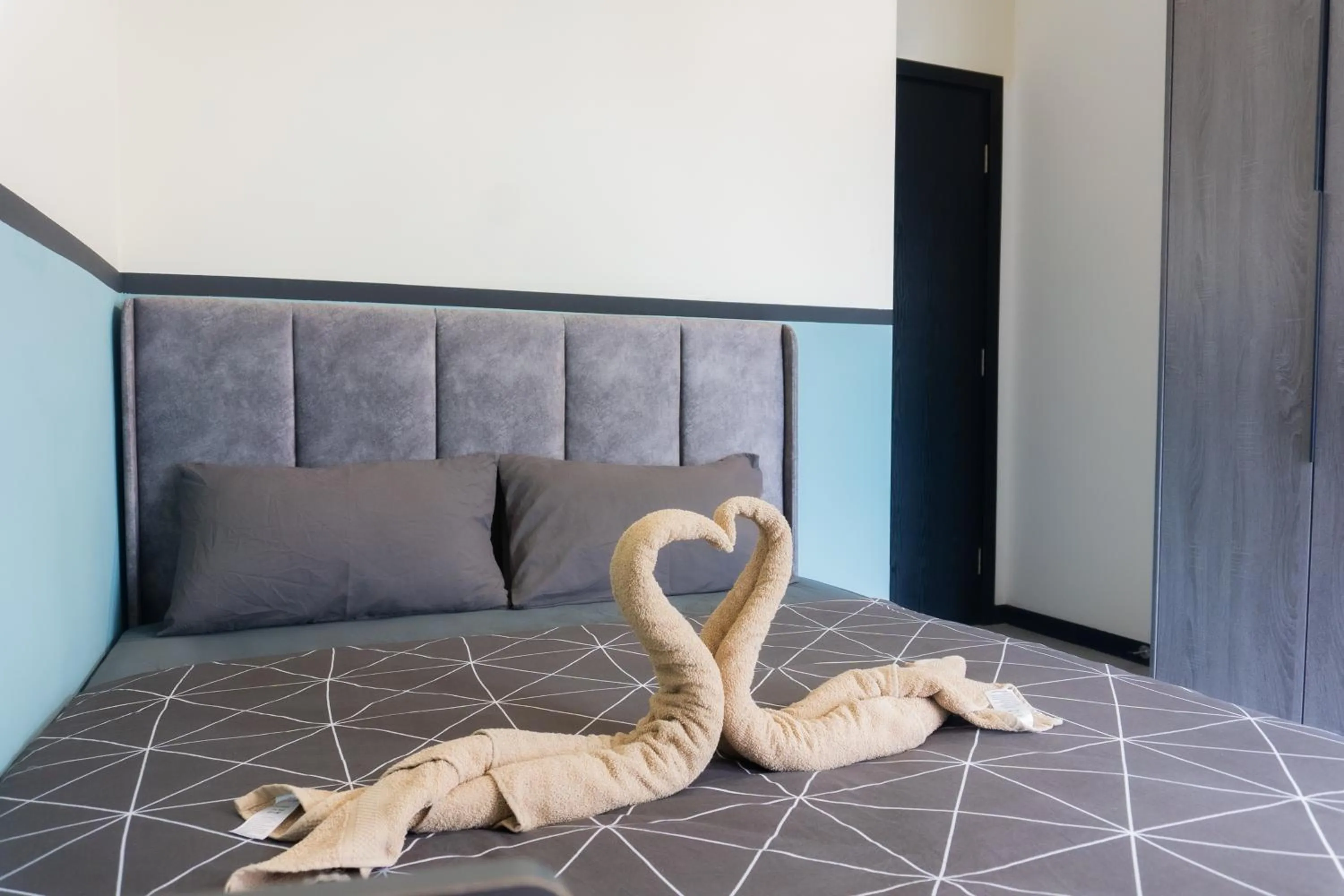 Bed in NeuSuite Cozy Studio by GUESTONIC