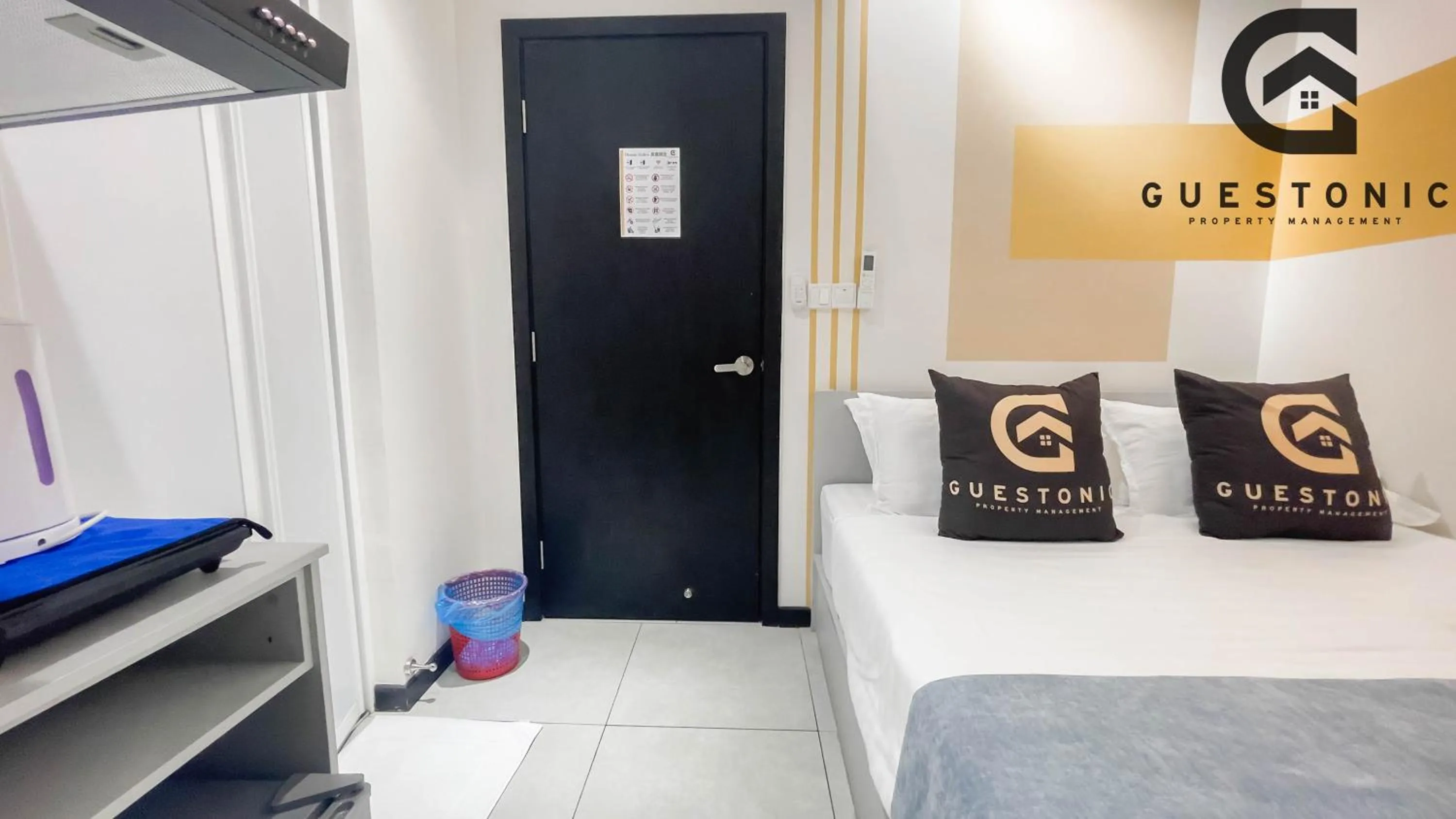 Bed in NeuSuite Cozy Studio by GUESTONIC