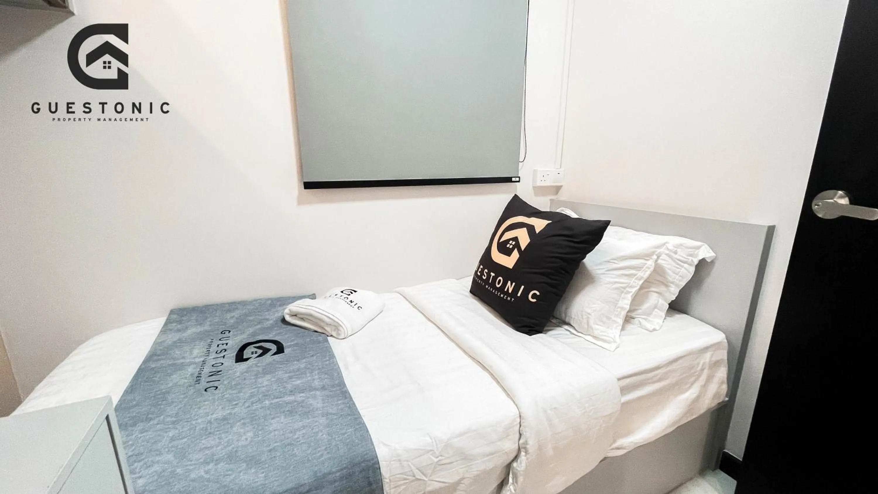 Bed in NeuSuite Cozy Studio by GUESTONIC