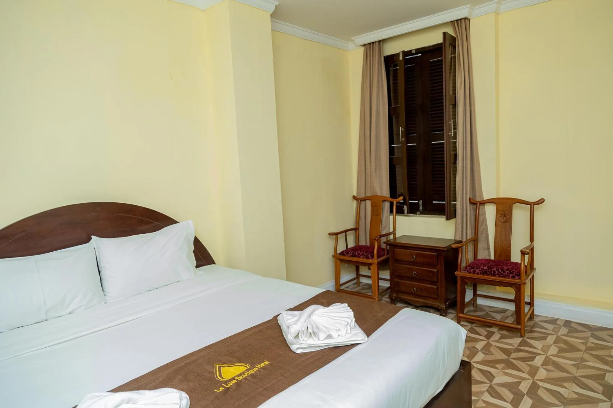 Bed in Le Luxe Boutique Hotel