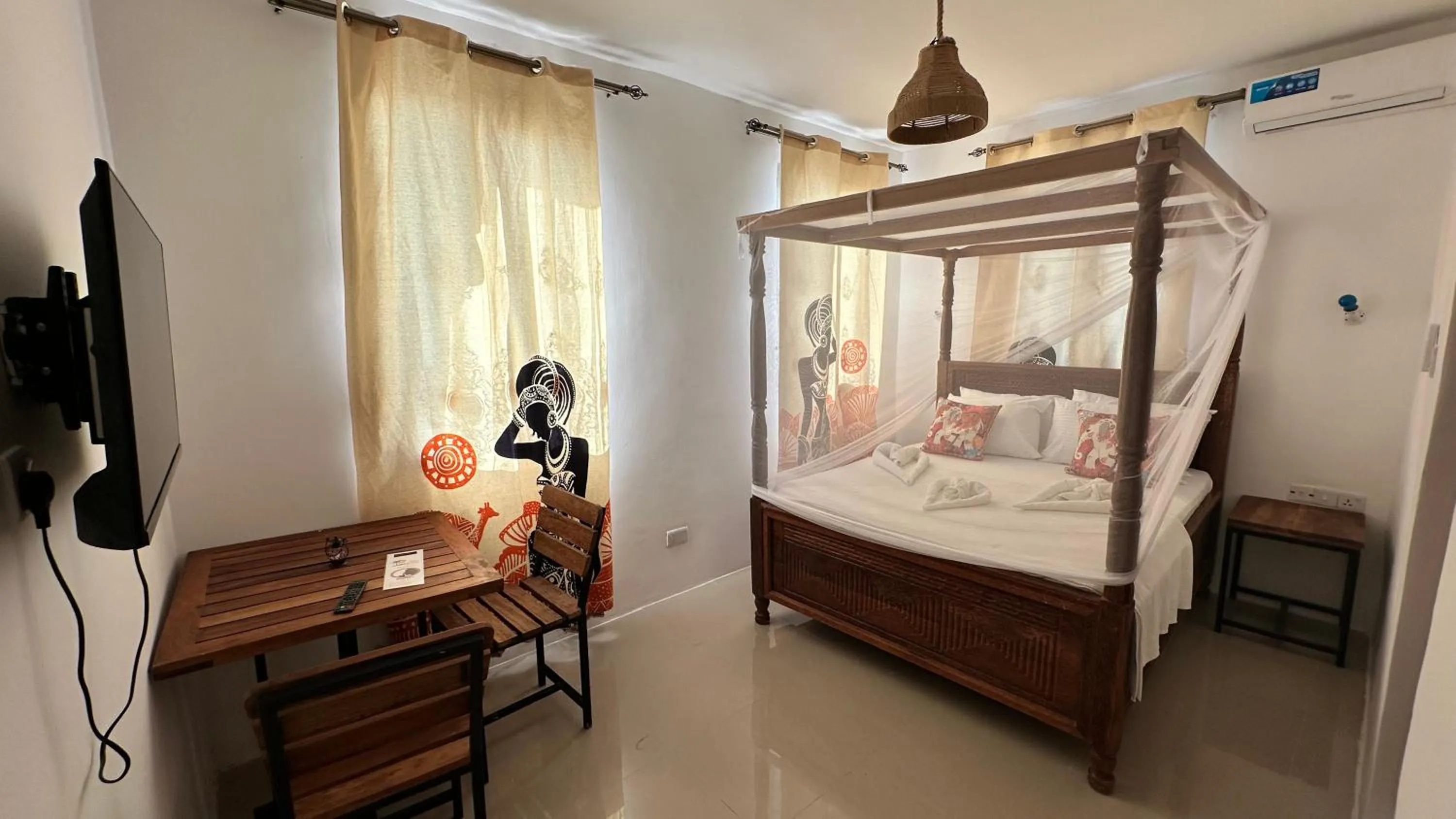 TV and multimedia, Bed in Light of Zanzibar Hotel