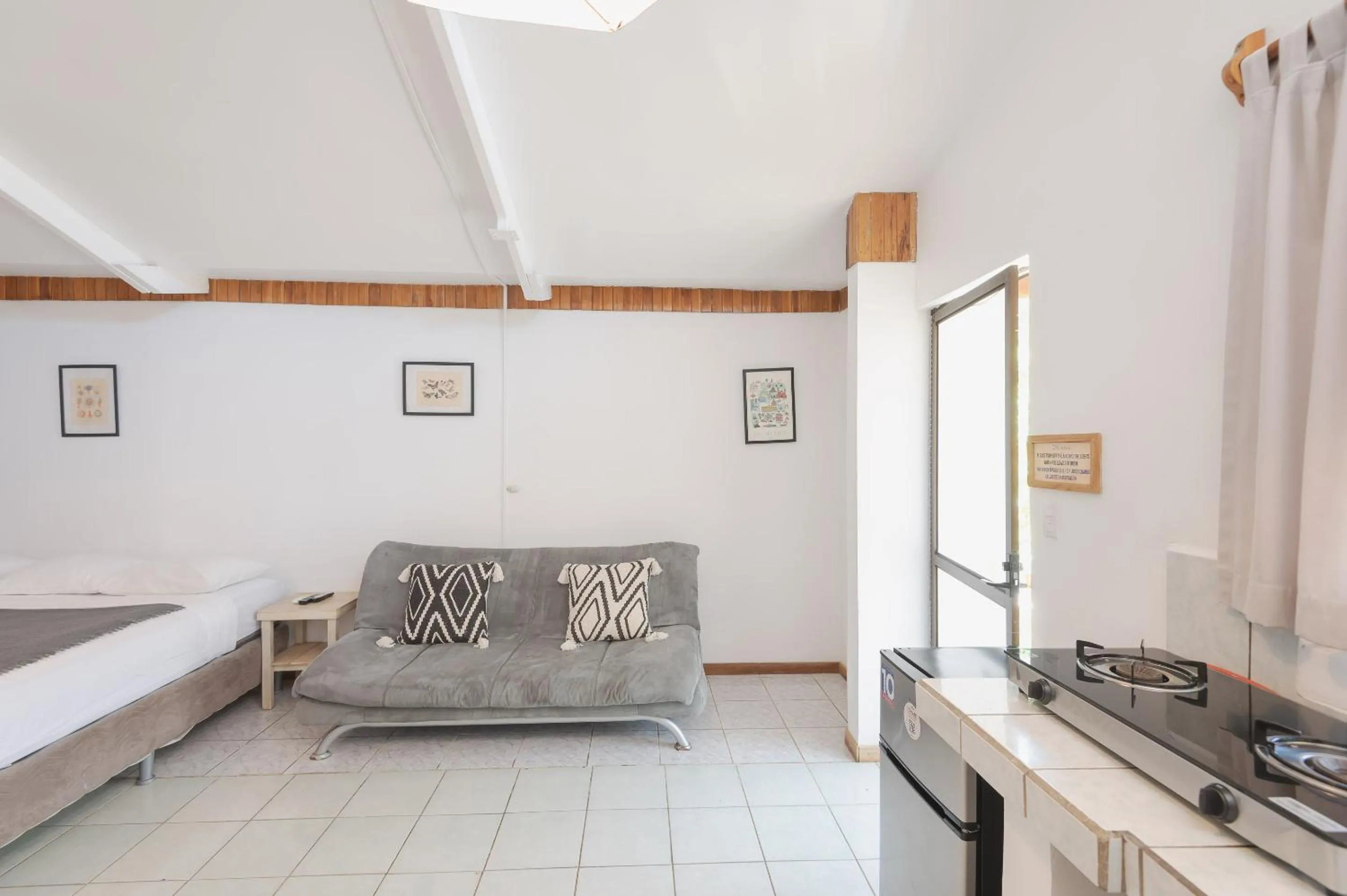 Seating area, Bed in Maoritsio Garden Studios