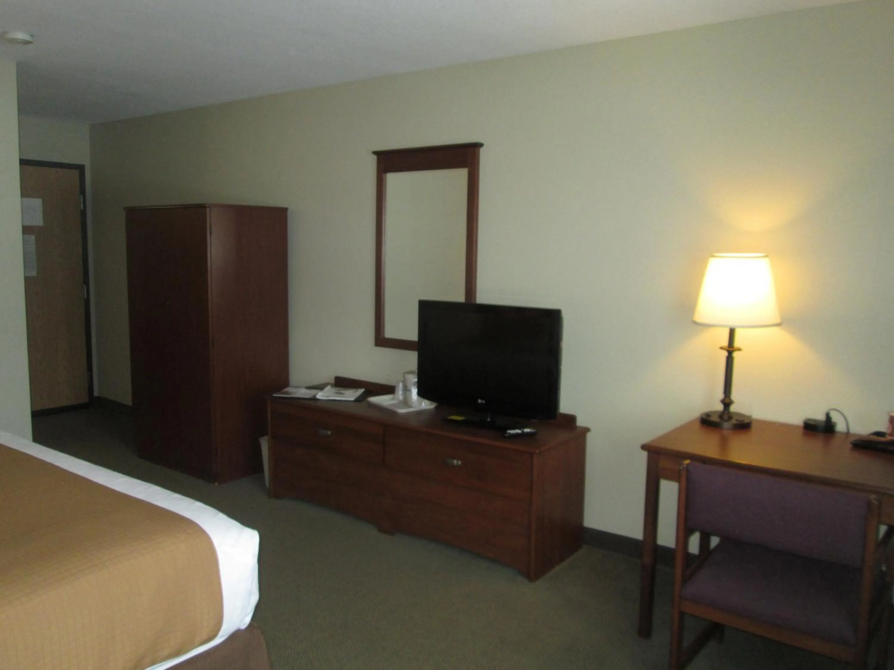 Bed in AmericInn by Wyndham Charlevoix