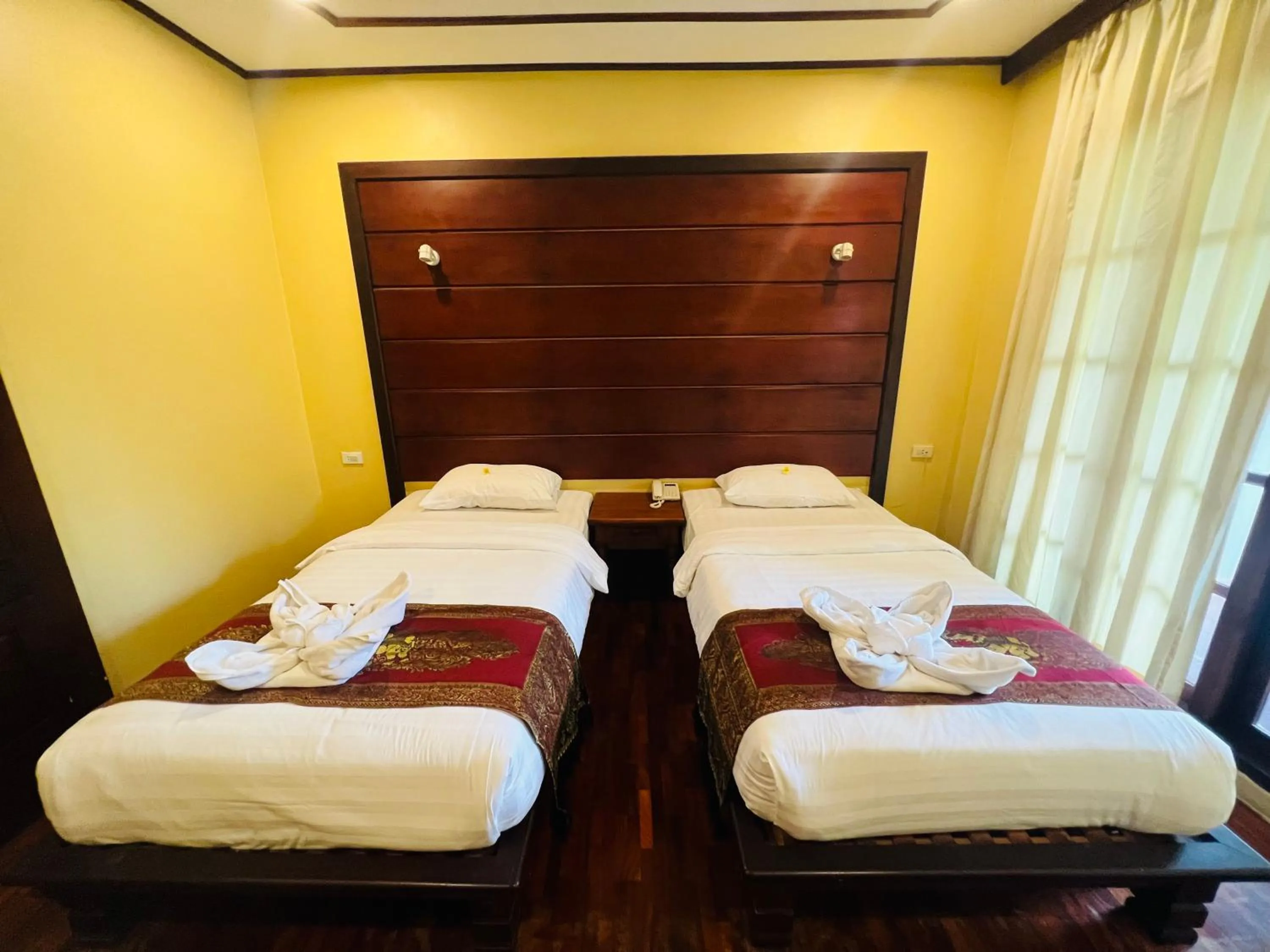 Bed in Meuangluang Hotel