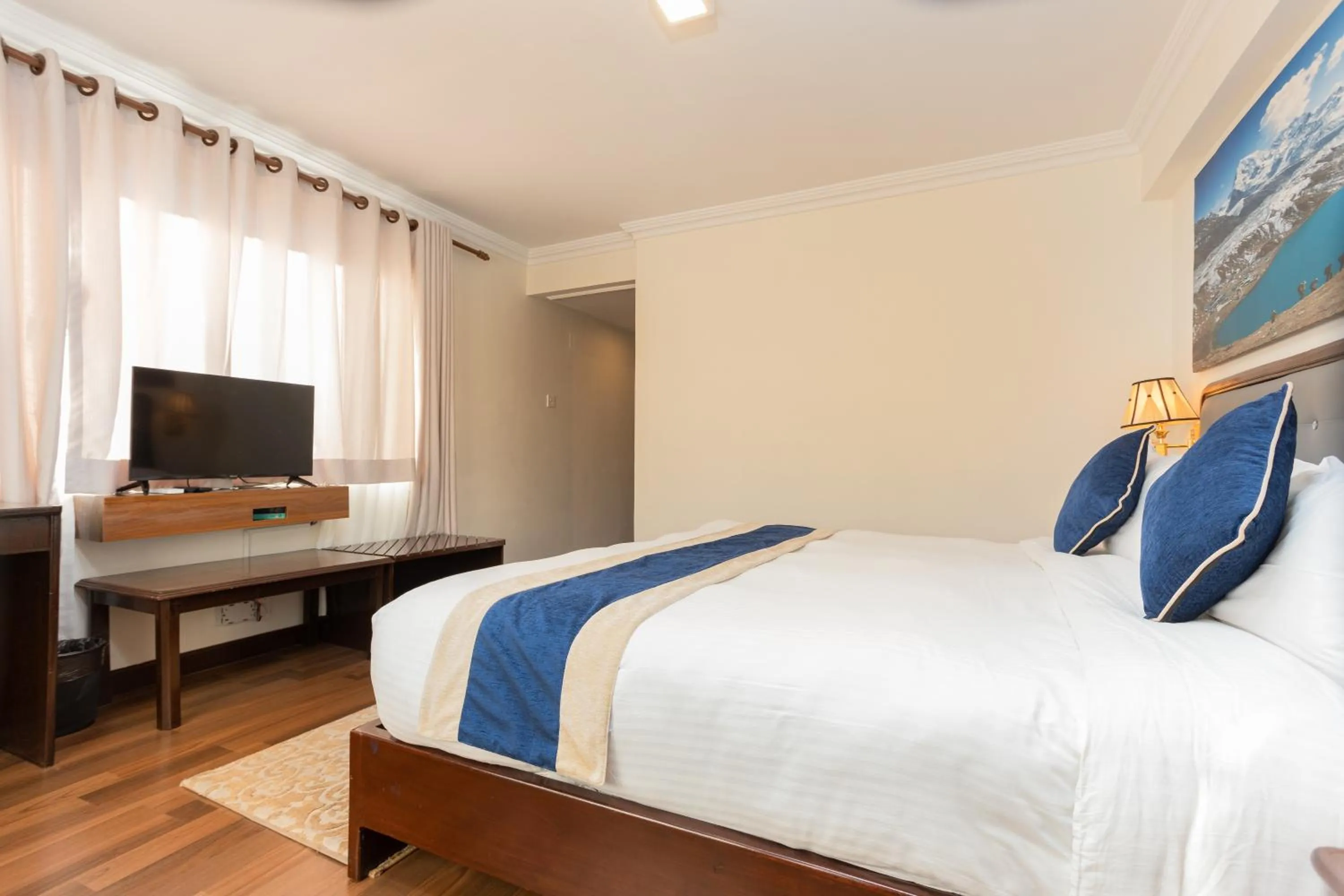 Communal lounge/ TV room, Bed in Kathmandu Business Hotel