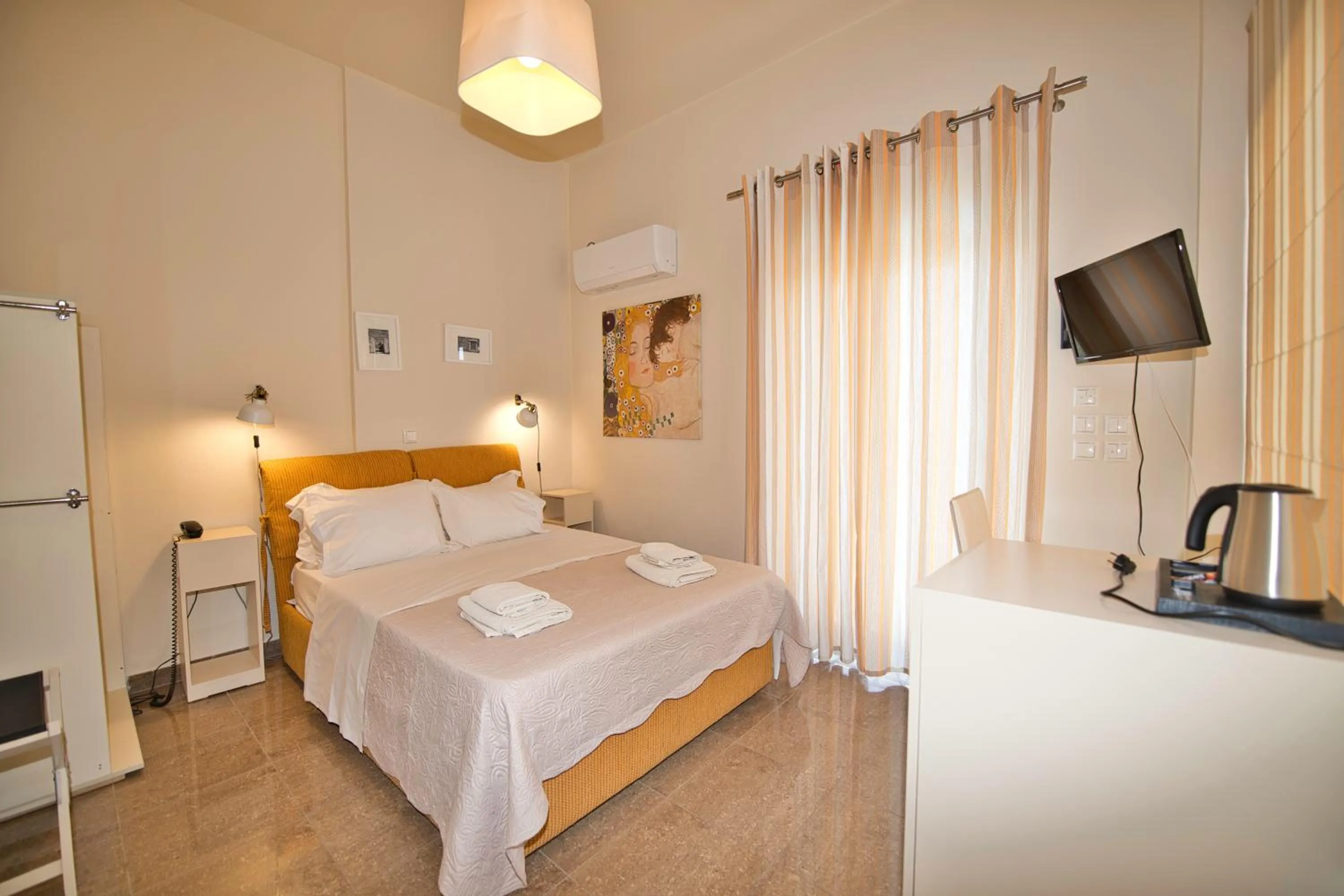 Bed in Marini Luxury Apartments and Suites