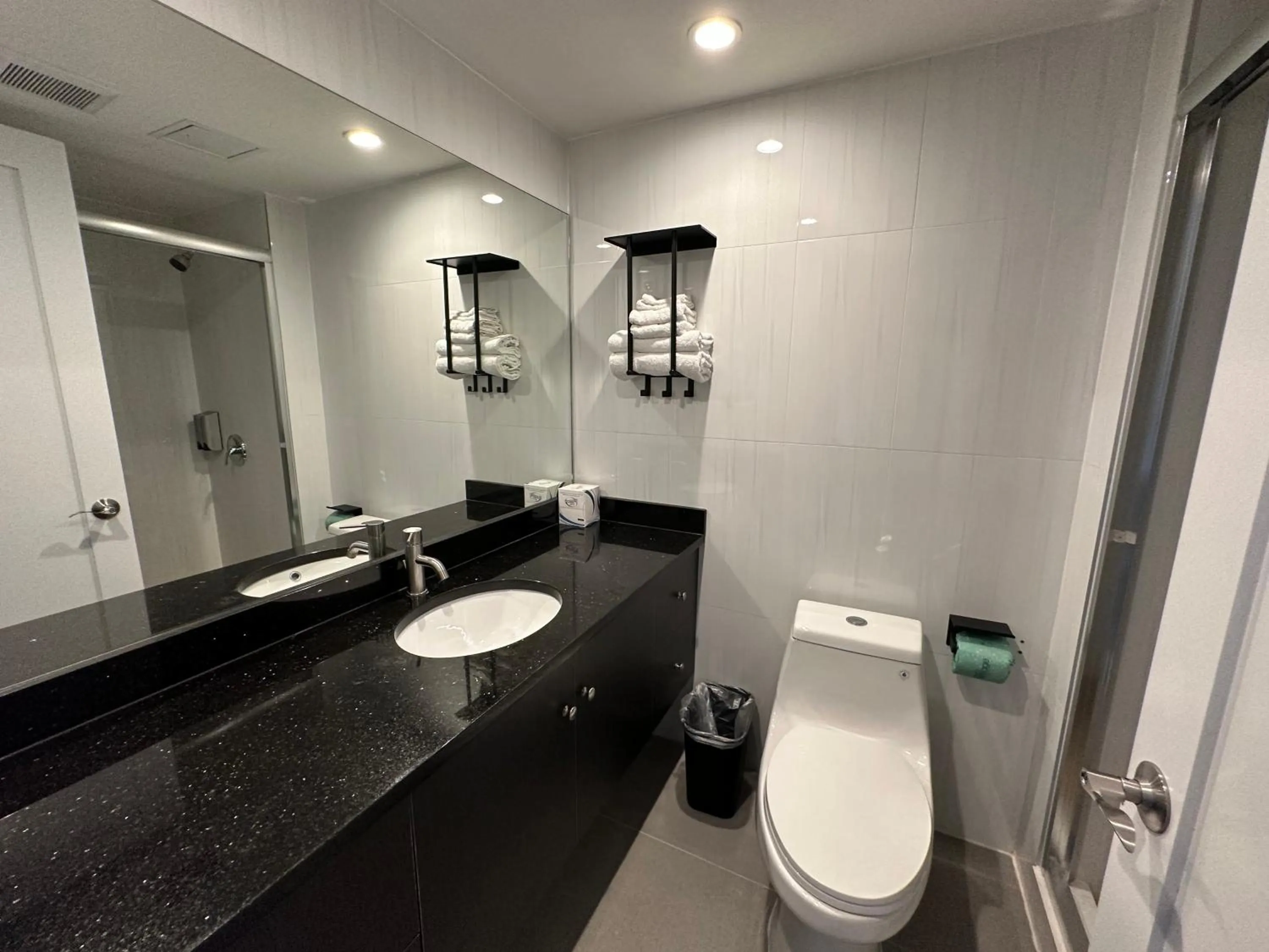 Toilet in Regal Inn & Suites New York LaGuardia Hotel