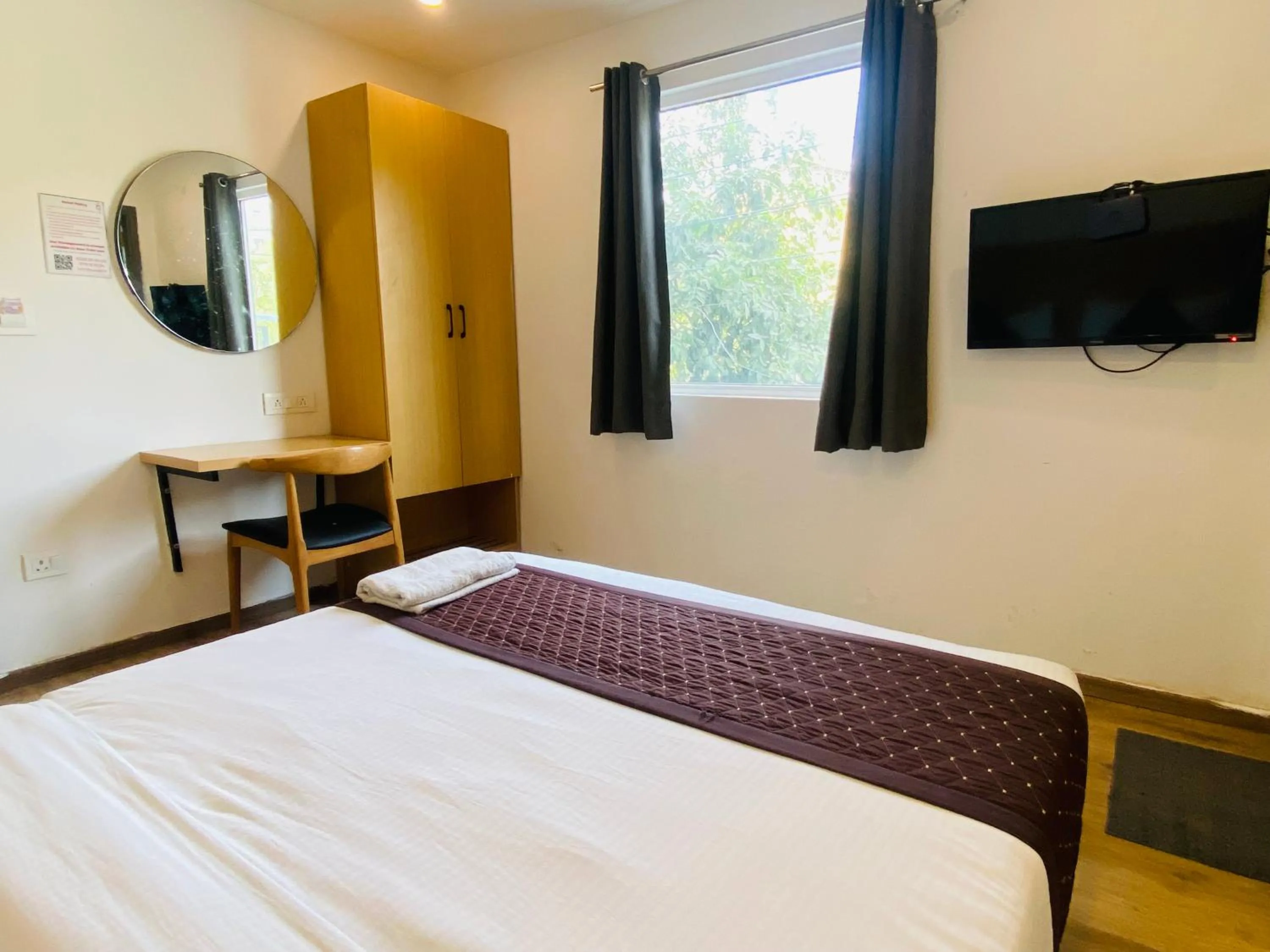 Communal lounge/ TV room, Bed in Qotel Comfort IP Residency East Delhi Preet Vihar