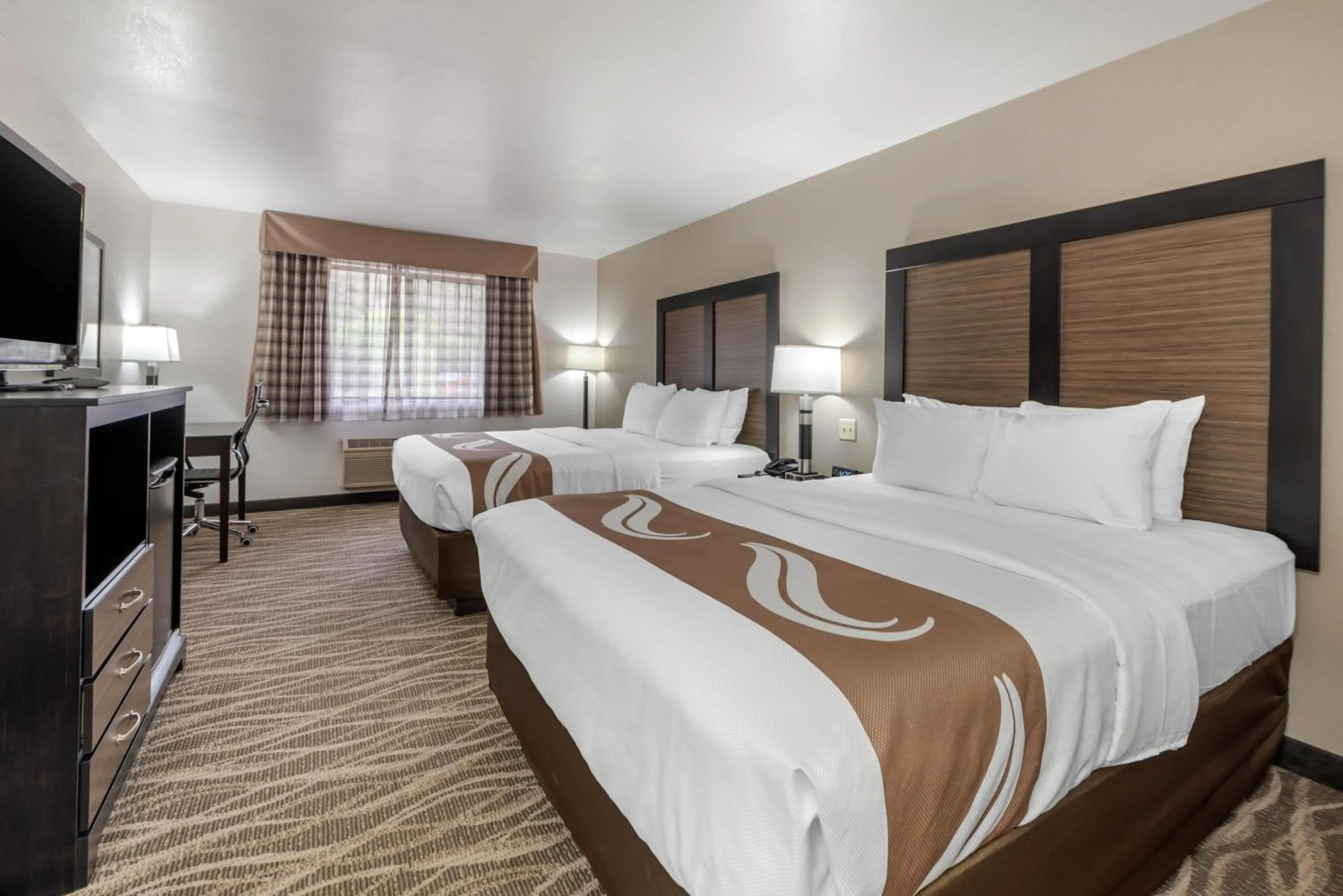 Bed in Quality Inn & Suites