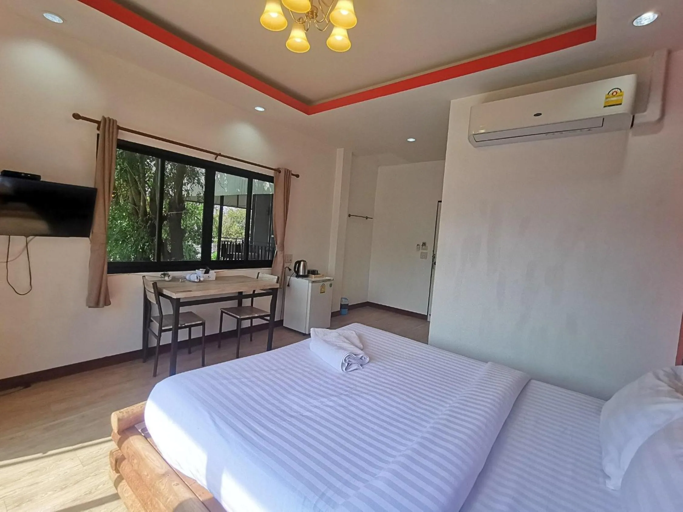 Bed in Kan Home Hotel