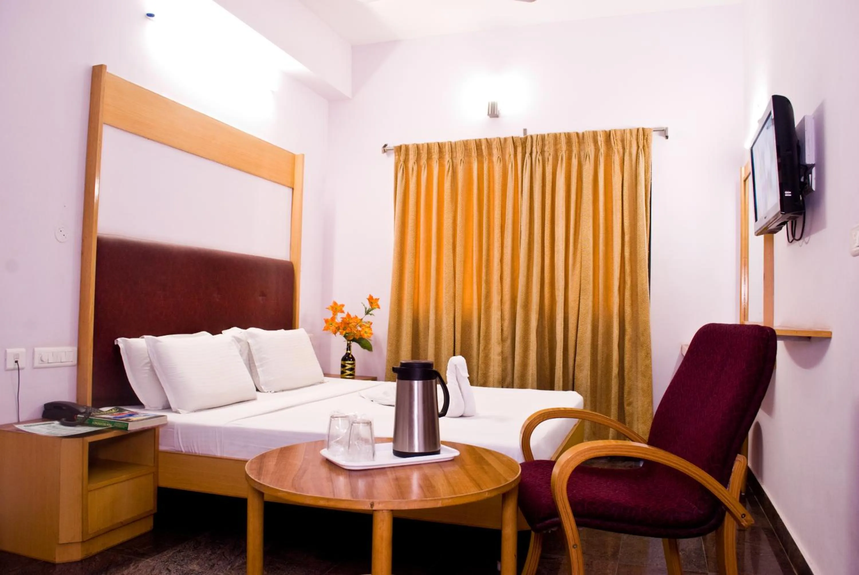 Bed, Seating Area in Hotel Rajadhane Madurai