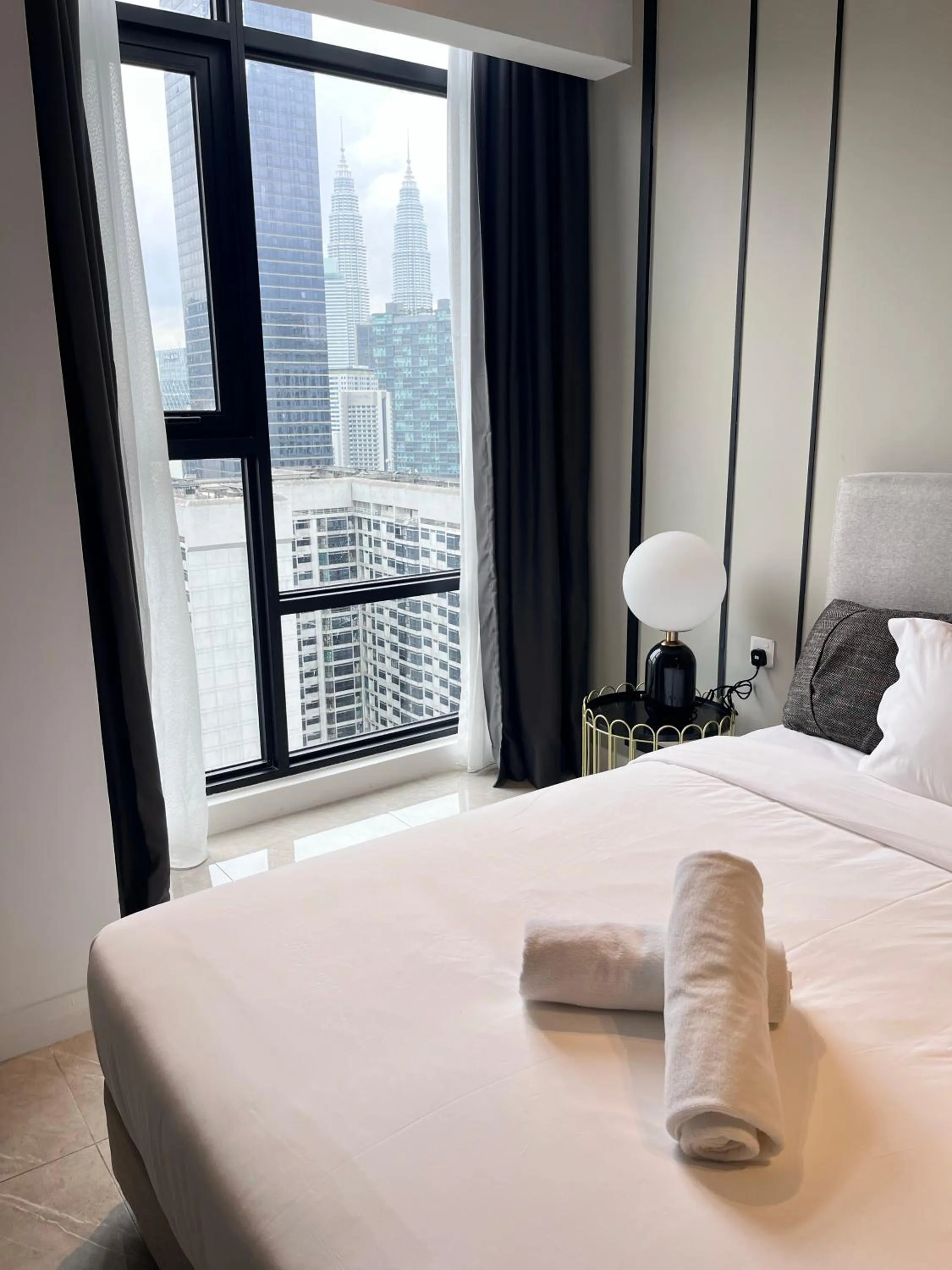 Bed in Axon Residence at Pavilion KLCC KL Tower view by KIMIRO