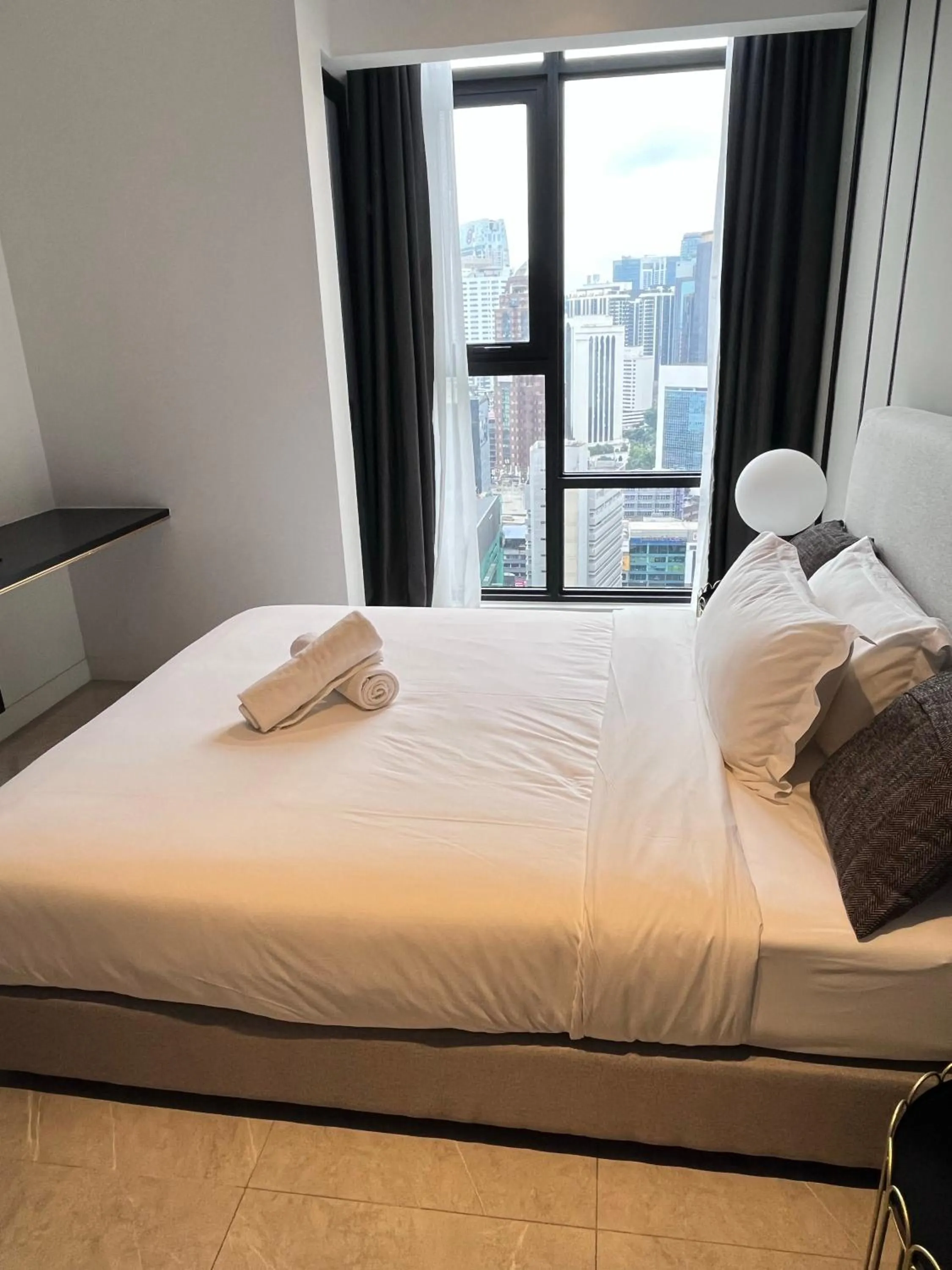 Bed in Axon Residence at Pavilion KLCC KL Tower view by KIMIRO