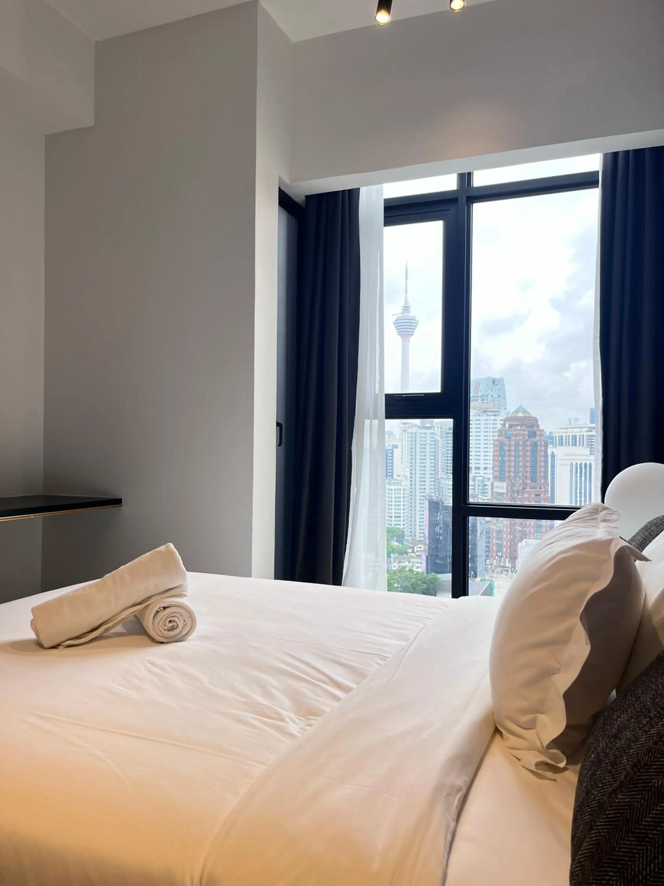 Bed in Axon Residence at Pavilion KLCC KL Tower view by KIMIRO